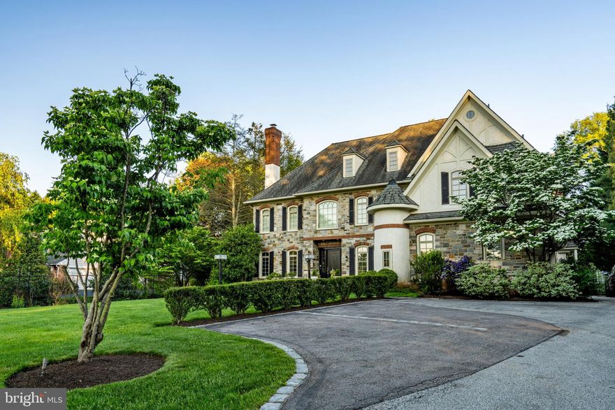 Nestled on an over half-acre set back from the road, this elegant home boasts five bedrooms and four full bathrooms, beautifully combining ample space with refined style.
The entry through gates adorned with stone pillars leads to a parking space, driveway and a three-car attached garage. Inside, the central hall ushers you into the elegant living room, complete with a stately fireplace and picturesque views of the well-manicured front yard. A separate study with glass doors provides a quiet retreat, while the formal dining room is poised for hosting splendid dinners.
The heart of the home, the kitchen, features a functional island, granite countertops, and a six-burner stove. It opens to a family room with cathedral ceilings, a cozy fireplace, and an oversized window framing the backyard. This open layout ensures that both cooking and socializing can be effortlessly enjoyed. The breakfast area, with its expansive windows, offers peaceful garden views and access to the back porch—perfect for peaceful morning coffee.
Upstairs, the primary suite commands attention with its hardwood floors, walk-in closets, and an additional fireplace, creating a luxurious retreat. This suite includes a lavish bathroom with double sinks, a separate shower, and a soaking tub. Four additional bedrooms, 3 of which come with their own bathrooms, ample closet space, and wall-to-wall carpeting. A convenient laundry room completes this floor.
Outside, the property features a below-ground pool, a spacious backyard, and a patio, all enclosed by a fence for privacy and security. This outdoor space is ideal for both serene solitude and vibrant entertainment.
Situated on the esteemed Main Line, the home offers both charm and convenience, with proximity to the Village of Gladwyne, great schools, major corporate centers, and straightforward access to the city and airport.