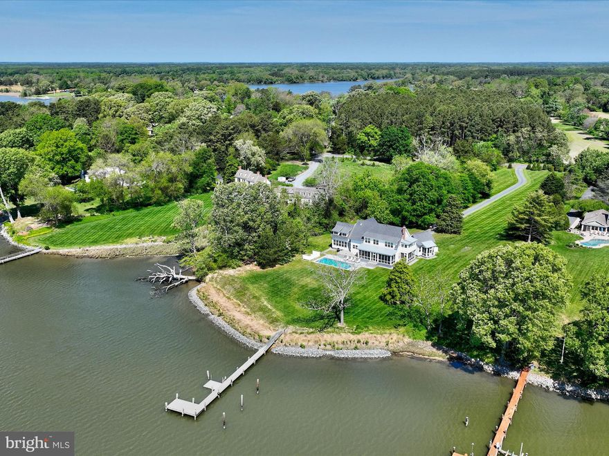 Stunning Ilex-built modern farmhouse set on over 3 acres along scenic Glebe Creek. This thoughtfully designed home features open-concept living with seamless sight lines from the kitchen through the dining area to the living room, creating an ideal space for everyday living and entertaining. A spacious screened-in porch extends from the main living areas and leads out to a waterside pool with an automatic cover and heater—perfect for enjoying indoor-outdoor living year-round.

Just off the mudroom, a sunny family room offers a cozy gathering space. The main level also includes a private guest suite tucked away for maximum privacy, complete with a loft, ensuite bath, and its own screened porch. Additional highlights on the main floor include a powder room, a butler’s pantry with laundry, and a screened porch off the living room.

Upstairs, the serene primary suite features a beamed ceiling, custom built-ins, an elegant ensuite bath, and a private sleeping porch. A separate children’s wing includes two charming bedrooms, each with dual built-in beds, and a shared bath. Two additional bedrooms, a hall bath, a walk-in linen closet, and a laundry closet complete the upper level.

Outside, a detached three-car garage includes a converted bay, now serving as an exercise room. Enjoy waterfront living with a private dock featuring a floating dock, riprapped shoreline, and picturesque pool area—everything you need for a peaceful retreat or active lifestyle.

Easton, Maryland, known as the New Hamptons of the Chesapeake Bay by Forbes Magazine, is conveniently located 1.5 hours from D.C. and Baltimore, and 2 hours from Philadelphia. Just minutes from fine dining, shopping, healthcare, theatres, galleries, museums, golf courses, a country club, a yacht club, and a jet airport.