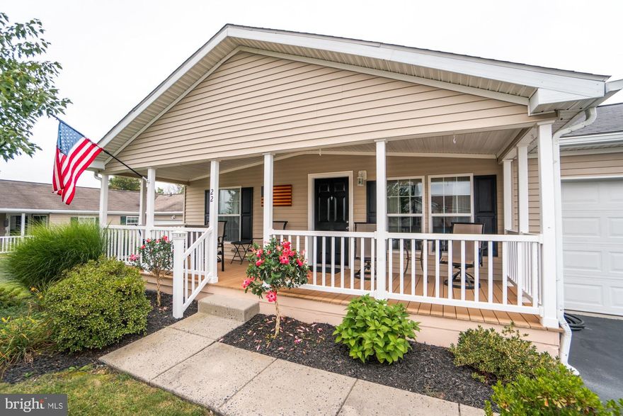 Nestled within this charming 55-plus community sits an impeccably kept home both inside and out.  The well-manicured and beautifully landscaped yard welcomes you to this home.  The very popular Holly model greets you with a quaint covered porch which extends the front of the home.  The home's East facing front allows an ideal spot for morning coffee in the warm sun if desired, but the mature tree allows for a shaded area as well. The evening hours are also a perfect time to relax on the porch. The open floor plan includes an elegant living room, dining and kitchen area and family room which emphasizes the spacious but cozy feel.  Time spent in the kitchen will be a pleasure with all the wonderful amenities including both pendant and recessed lighting, plenty of cabinetry and counter tops, a large island, double bowl sinks including a garbage disposal, built-in microwave, flat top electric stove, an additional wall of cabinets and easy access to the laundry room.   An extension of the home’s practical floor plan is a slider to the beautiful composite deck with a large gazebo.  The gazebo bonus allows you to enjoy the comfort of outdoors in various weather conditions.  The lot backs to woods for added privacy.  The bedrooms are strategically positioned from front to back of the home.  The spacious primary bedroom is located towards the back of the home and houses your own full bath with a double bowl sink vanity, a four mirrored medicine cabinet, a double shower, and a custom-built linen closet.  Easy access from the extended two car attached garage allows entry into the kitchen.  So nice to carry those groceries right where they need to be!  All in all, this lovely one floor living home within a desired 55-plus community offers an environment of comfort and easy living.  Don’t delay, schedule your tour before it’s gone!