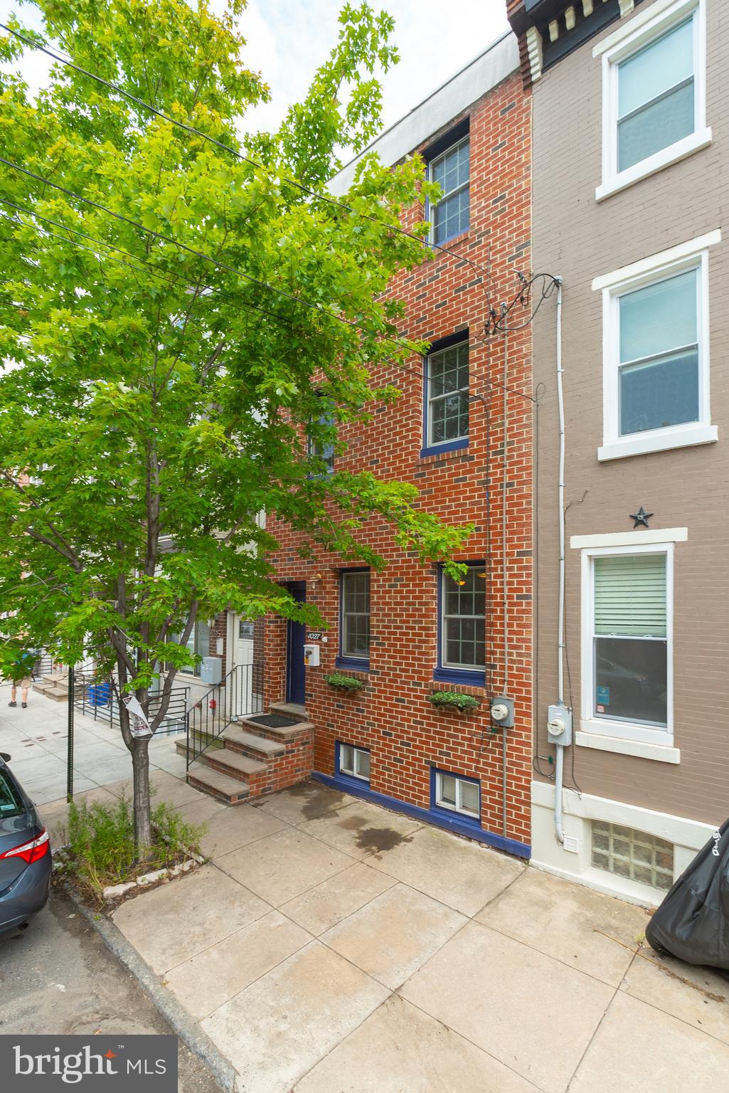 welcome to 1027 S 18th Street, a spacious 3-bedroom, 2.5-bath home tucked along a beautiful tree-lined block in Graduate Hospital. Just a few blocks from Lincoln Square’s convienet shopping such as Sprouts, Target, Wine & Spirits & more, and an easy walk into Rittenhouse for the top restaurants, cafes, and nightlife, this home delivers the ultimate in urban convenience and comfort.
Enter through the classic tiled vestibule that opens into an airy, open-concept living and dining area with crisp wainscoting and warm natural light, a powder room on this level adds both ease and functionality. The kitchen flows to a seriously spacious private patio, ideal for happy hour, morning coffee, or your next dinner party. Upstairs, the second level features two generous bedrooms and a sleek shared full bath, plus a stacked washer/dryer to keep life efficient. The entire third floor is dedicated to your primary retreat complete with a ceiling fan, a massive walk-in closet that connects to the en-suite bath, and access to your brand-new mainatance free Trex rooftop deck that was installed in 2024. Designed for summer soirées, sunset views, and weekend lounging. A full unfinished basement provides exceptional storage and potential for customization. Bonus upgrades include a brand new roof in 24' with a 10 year warranty, new curb trap in 25' and water heater replaced in 20'. This is city living for those who want space and style, and convenient location close to everything you love about Philly right out your doorstep.