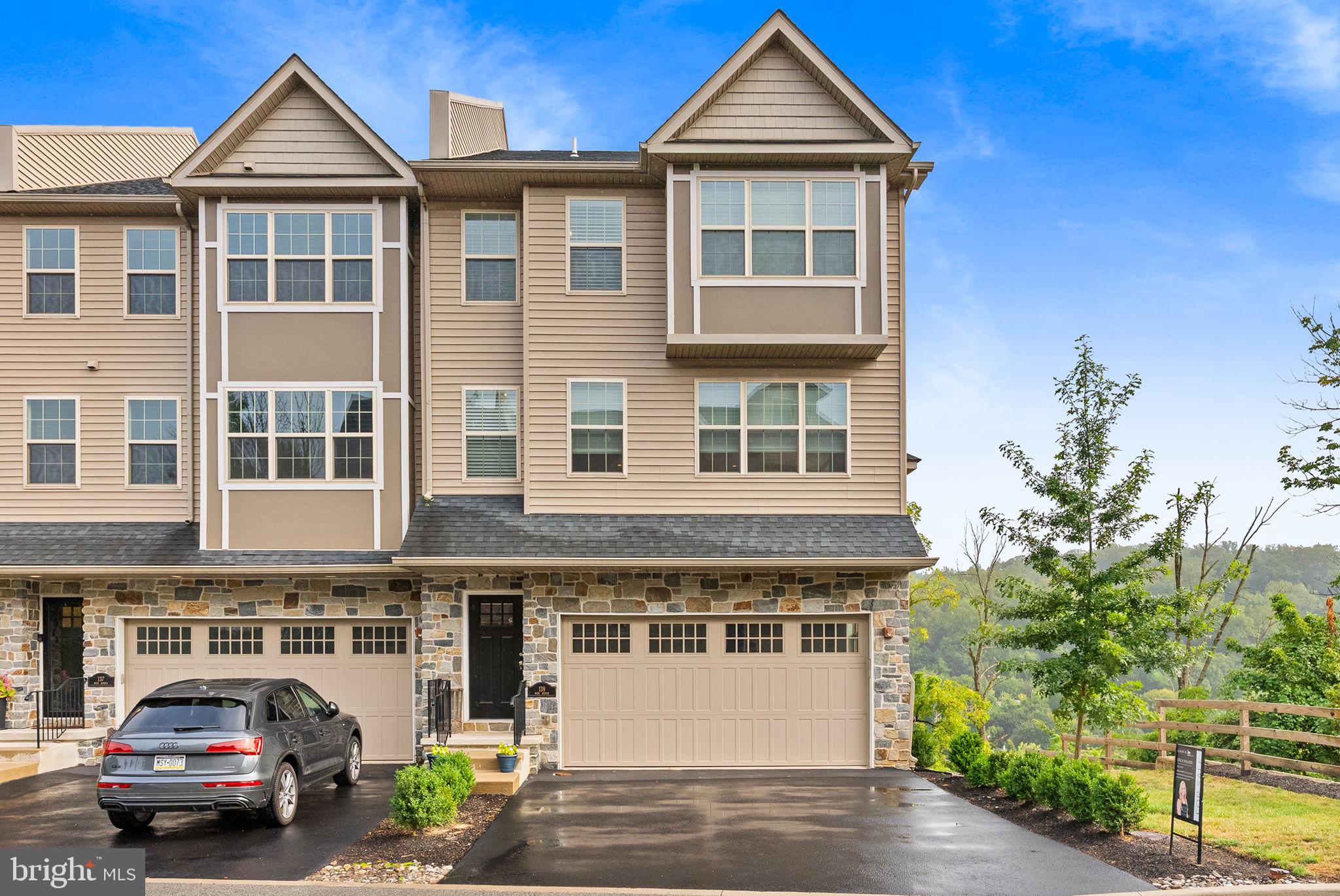Perched high above the borough, this end-unit townhome offers sweeping, mountain-like views that will take your breath away. Built in 2019 and thoughtfully designed across four levels, the home combines modern style with everyday functionality.
Step inside to soaring ceilings, an open layout, and a sleek, modern kitchen that flows seamlessly into the living and dining spaces. Two balconies extend your living outdoors, the perfect spots to relax and take in the extraordinary panoramic views.
Upstairs, you’ll find three spacious bedrooms plus a versatile loft that can easily serve as a fourth bedroom, office, or playroom with a plumbing rough-in for a future full bathroom. The primary suite provides a serene retreat, while oversized windows throughout the home bring in natural light and frame the incredible scenery.
Additional features include 2.5 bathrooms, a two-car garage, an elevator shaft for future convenience, and an unfinished basement for storage.
West Conshohocken offers a quieter, less congested atmosphere than the borough, yet you’re just minutes to major highways, train stations, dining, and shopping.
This is where elevated living meets effortless convenience—don’t miss the opportunity to call 139 Moir Ave home.