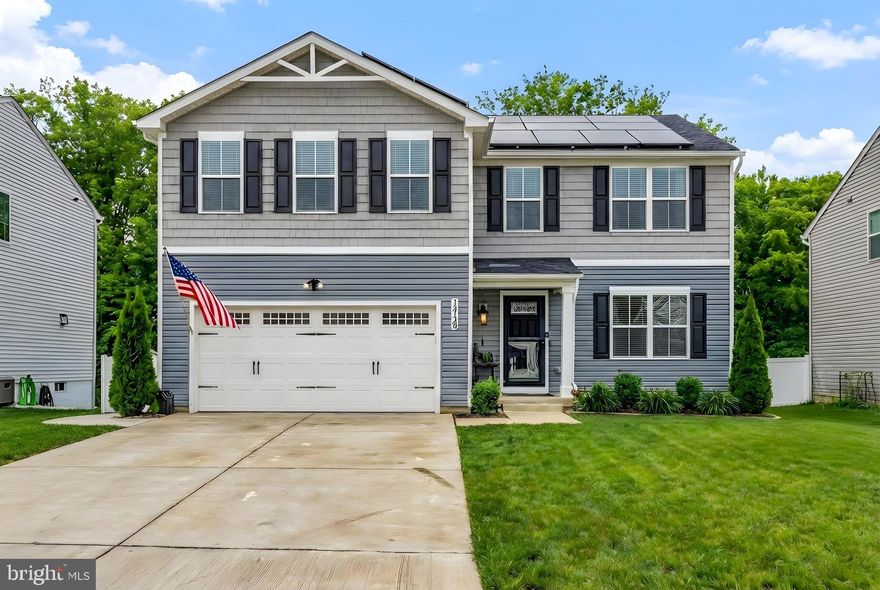 Well-maintained and thoughtfully upgraded,  5 bedroom 3.5 bath home in the desirable Hopyard community, offering a modern, energy-efficient design, finished basement living, and a premium lot backing to wooded open space. This home combines a highly functional floor plan with meaningful post-construction improvements that enhance comfort, efficiency, and everyday livability.

The main level features an open-concept layout filled with natural light and designed for both daily living and entertaining. The kitchen has been upgraded with quartz countertops, tile backsplash, and under-cabinet LED lighting, providing a clean, modern aesthetic with excellent functionality. Luxury vinyl plank flooring runs throughout the home, offering durability, low maintenance, and a cohesive look.

Built with energy efficiency in mind, the home benefits from modern construction practices including an efficient building envelope, energy-conscious materials, and high-performance systems that contribute to lower utility costs and year-round comfort. An owned solar system with 34 panels further enhances efficiency and long-term operating savings.

The upper level provides comfortable bedroom accommodations, while the finished basement adds approximately 700 square feet of permitted living space, including a legal bedroom with egress and closet, a full bathroom, a recreation room, and a large mechanical and storage room—ideal for guests, multigenerational living, or flexible home office use.

Outdoor living is a standout feature. A large rear deck with extra-wide, permitted stairs leads into a private, wooded backdrop, creating a peaceful, retreat-like setting. The fully fenced backyard backs to forested open space, where a natural gully and gently flowing creek below enhance privacy and provide a serene connection to nature—an oasis rarely found in a neighborhood setting.

Additional exterior improvements include permanent exterior LED lighting, a concrete trash bin pad with enclosure, and well-maintained outdoor spaces designed for both function and enjoyment.

Practical infrastructure upgrades include a 50-amp / 240-volt garage outlet suitable for fast EV charging or welding, supporting modern lifestyle needs.

Residents of Hopyard enjoy access to community amenities including a clubhouse and gym, along with convenient proximity to the Hopyard Landing boat dock. The home’s location offers easy access to neighborhood amenities while maintaining a quiet, private rear-lot setting.

This property presents a compelling opportunity within Hopyard, combining energy-efficient construction, permitted upgrades, flexible living space, and a highly desirable wooded lot.