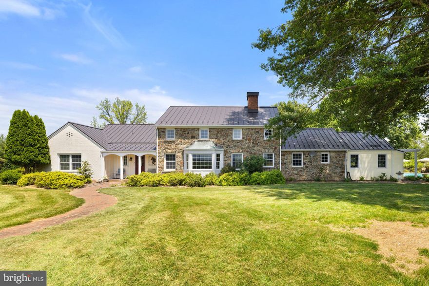 Charming Country Retreat with Mountain Views Near the Village of Philomont

Welcome to this beautifully maintained property on ten private acres just outside the Village of Philomont, offering peaceful western views of the Blue Ridge Mountains. The residence features a main-level primary suite and a thoughtfully updated kitchen with granite countertops that opens to a formal dining room. Both the cozy living room and the den include fireplaces and built-in bookcases, adding warmth, character, and functionality. An additional main-level room serves well as a home office, art studio, or fourth bedroom. A spacious laundry and mudroom are conveniently located just off the kitchen.

Upstairs, two comfortable bedrooms share a full bath.

The exterior invites relaxation and recreation, with mature landscaping, a private in-ground pool, and two patios—one covered and one open—perfect for outdoor entertaining. The property is fully fenced for horses or livestock. Equestrian amenities include a three-stall stable with an additional wash stall, and multiple paddocks. The property also has a detached two-car garage.

The home's exterior features a classic combination of stone, brick, and vinyl siding for timeless appeal and low-maintenance living. A private well yields 25 gallons per minute and is 260 feet deep.
This property offers an ideal blend of comfort, natural beauty, and the enduring charm of Virginia countryside living.

Professional photos will be posted on Tuesday, June 24.