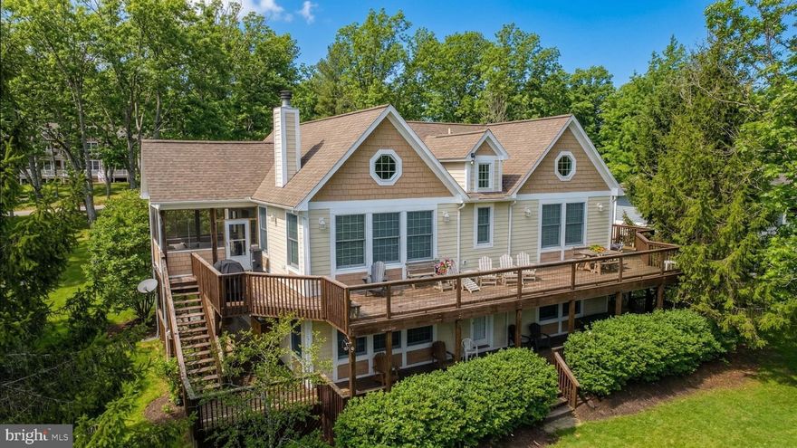 Lakefront Craftsman in one of Deep Creek Lake's finest communities. This 5-bed 5-bath home directly adjoins Deep Creek Lake with 100 ft of frontage and your very own boat slip. Clean, contemporary build with 3,788 finished sqft on 0.86 acres. Recently updated with new flooring, modern kitchen, bathroom vanities and rustic timber accents. Open main level with cathedral ceilings, hardwood floors, wood-burning fireplace, and a quartzite-topped kitchen with island and breakfast bar. Main-level primary suite plus two additional ensuite bedrooms. The walkout lower level adds a second living space with a gameroom, gas fireplace, and wet bar. The attached Indoor pool with a brand new liner sets this one apart. EV Charger included. Outdoor living includes a hot tub, fire pit, and a level yard at the water’s edge. Wraparound and screened decking to take in the lake views. An established rental, "Stilwater Serenity" makes an excellent private mountain/lake retreat or something that helps pay for itself when you're not using it. Call today for details!