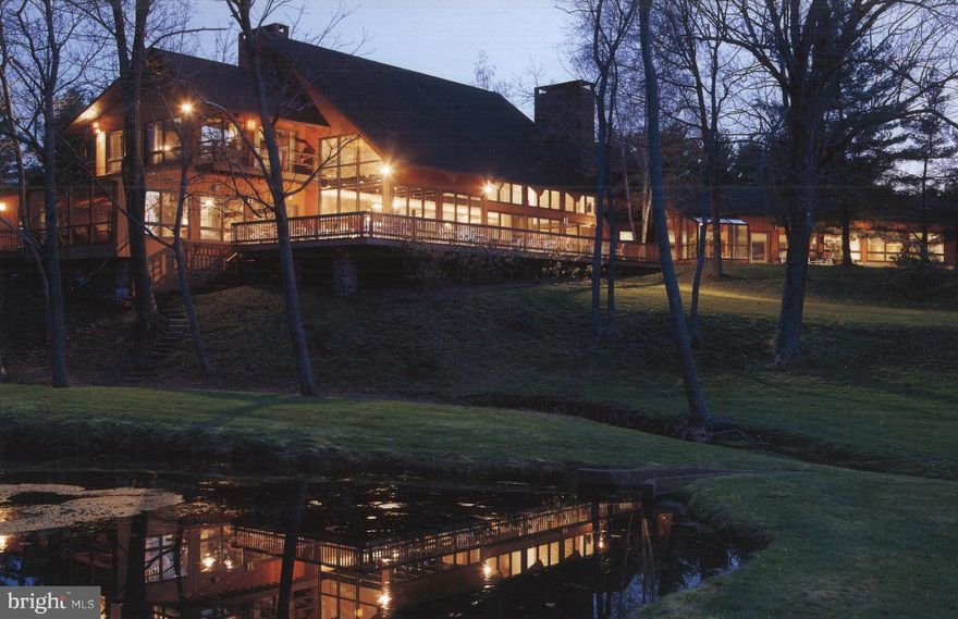 Visit https://bit.ly/1729Shale3D for a 3D walkthrough, and https://www.seetheproperty.com/u/250420 for photos, floorplans & more!  Sequestered in a dramatic and memorable setting in which to live and entertain, this custom-crafted Bucks County contemporary is as unique as its location. The 12,125 square foot stone and cedar home overlooks a private lake that becomes one with the home through walls of windows, balconies, and generous decking. From every vantage point, whether inside or out, the vistas blend harmoniously with the home's architectural design, creating a living environment that is unique and soothing. Pondside has been designed to be a part of the landscape, to skillfully create a balance between the beauty of nature and the appointments made by man.The striking atrium is an invitation to the surprises to come. Interior spaces boast skylights, vaulted ceilings, walls of glass and creative living spaces for every need and expectation. All rooms have been designed to open gracefully to each other and yet be defined by use. The open living, dining, and family rooms accommodate every luxury and comfort. Vaulted ceilings and skylights create a sense of never-ending space, while stone fireplaces lend a feeling of natural warmth.The remodeled kitchen is designed for the most sophisticated gourmet, with copper front cabinets and stainless backsplash, granite counters, Viking appliances including two dishwashers, two ovens, two fridges, three ranges, and multiple sinks and work islands. A separate wet bar will make entertaining a delight. A breakfast area overlooks the acreage beyond, where only birds and wildlife will be your occasional visitors. Additional first floor spaces invite your family and friends to visit and enjoy. A recreation room is adjacent to a first floor bedroom suite and two first floor offices. A sunroom and pool table room open to the indoor heated swimming pool, dramatically set under a vault of cedar, and fed by its own rocky waterfall, along with a hot tub and sauna. In summer or winter, you will spend your days under the sky lit interior, regardless of weather conditions, luxuriating in the wealth of this creative design.Four additional bedrooms include a luxuriously-equipped master suite, with fireplace and a skylight as big as the heavens. Lofted above the first floor living spaces, and accessed by two staircases, these family spaces will delight.  This remarkable property contains 21 acres of lawn and woodland, secluded at the end of a long drive. Rarely does a home of this caliber become available, with absolute privacy and protected vistas, where you can hear grass grow .all in an enviable location in the serene environs of Upper Bucks County.