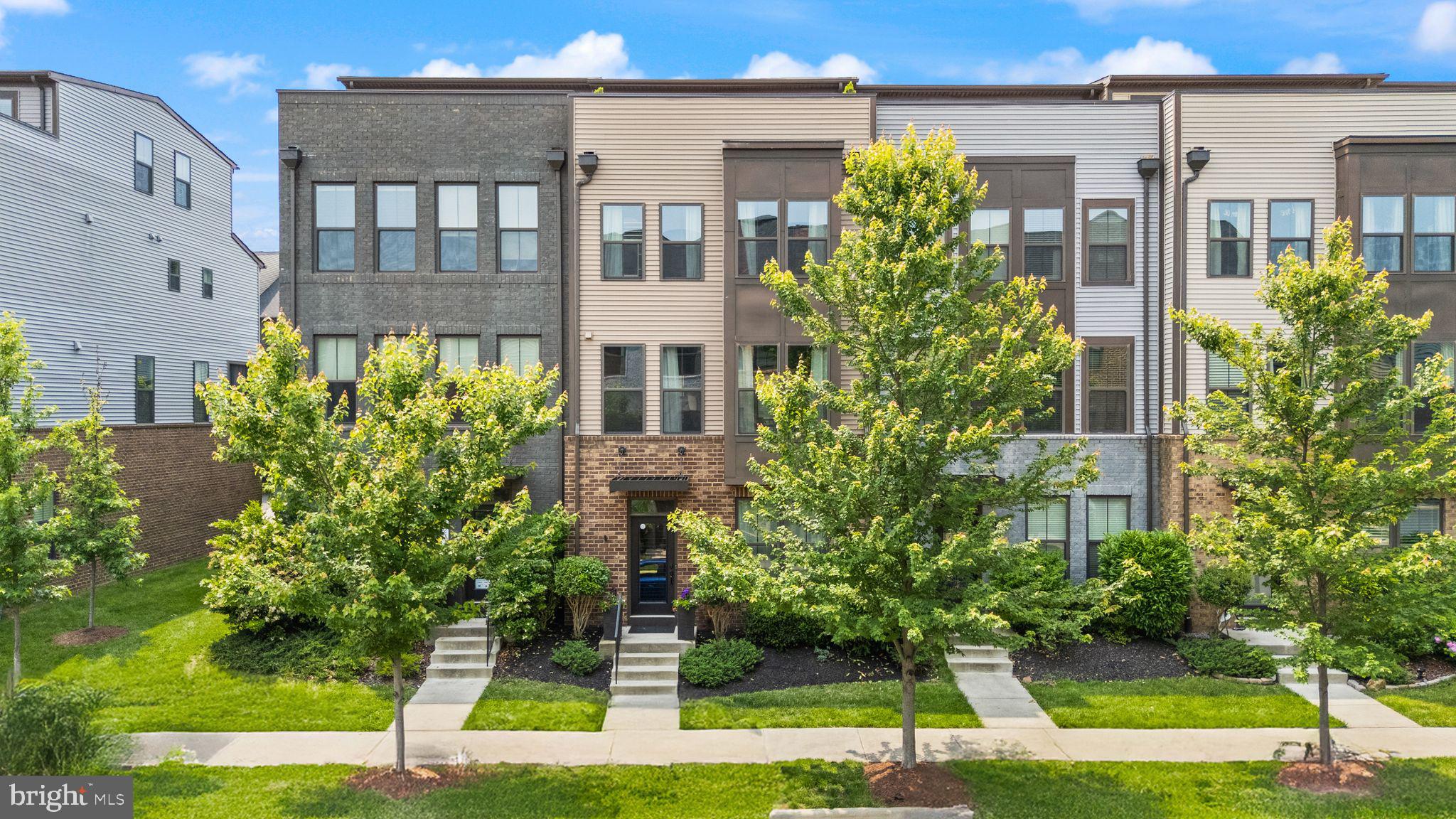 This exquisite 4 level, 4 bedroom 4.5 bath townhome with custom features will knock your socks off! Plus, enjoy outdoor space on the balcony and rooftop terrace, and the convenience of being just steps from the Ashburn Metro.
As you enter the home, you're greeted by a tiled entryway that leads to a private bedroom and full bath—perfect for guests or a home office. The built-in cabinet with Murphy bed conveys, maximizing functionality and space. The accompanying bath features granite counters and updated floor and shower tiles. Enjoy ample storage with a 2-car garage, hanging metal shelves (convey), a full driveway, and plenty of additional parking right in front and along nearby streets.
Upstairs, you're welcomed by a dramatic modern fireplace with full-height slate tile surround, flanked by custom built-in cabinets (also conveying). The open concept main living level features gorgeous engineered hardwood floors, a covered balcony with a second fireplace to cozy up during those chilly nights, and an entertainer’s dream kitchen. The kitchen boasts classic white cabinetry, granite countertops, and upgraded appliances, including a refrigerator, cooktop, and double oven. The center island layout flows beautifully into the great room and dining area. The dining room includes custom built-ins with granite top, a wine fridge, cabinets. In addition, the dining table conveys!
On the bedroom level, the spacious primary suite impresses with an inlaid tub & shower, granite counters, and upgraded tilework. The hall bath mirrors the same level of elegance, featuring quartz counters and premium tiles. Engineered hardwood runs throughout the hallway and continues into the expansive fourth floor loft—a large, flexible space ideal for a media room, office, or game room. The top-floor full bath includes quartz counters and upgraded tile in the shower and on the floor. Finish the day on your private rooftop terrace, where you can take in stunning sunrises and sunsets from your own outdoor retreat.
Additional perks include all the additional conveyances, oak stairs, custom blinds in powder room and loft level, and stacked, upgraded washer/dryer.
As part of the amenity-rich Westmoore community, you'll enjoy access to two expansive parks with playgrounds, a dog park, amphitheater, pavilion, clubhouse, pool, fitness center, and miles of walking and jogging trails. Unmatched convenience with proximity to Dulles Airport, Dulles Greenway, and shops, restaurants, and entertainment at Loudoun Station and Broadlands Marketplace—not to mention direct access to the Ashburn Metro!