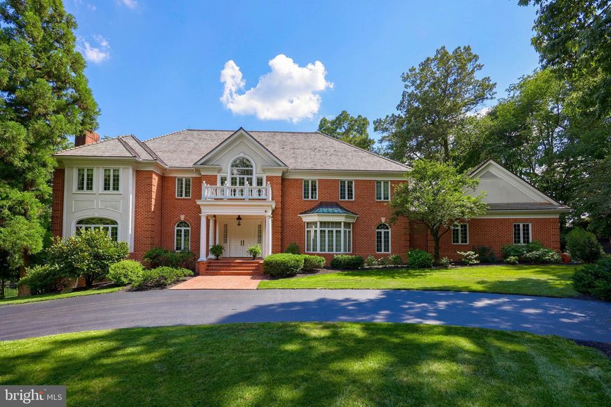 Enchantment awaits at this secluded 3.13 ac. estate nestled in a sun dappled clearing at the end of a private drive. Though schools, colleges, medical campuses, golf and attractions are only minutes away, you’d never know it from the peaceful shelter of its manicured grounds. The Georgian style home welcomes all with an arresting columned entrance featuring herringbone brickwork and double front doors, which open to a marble Foyer reminiscent of fairy tales, complete with cascading architectural staircase, balcony overlook and chandelier draped 23 ft. ceiling. Formal spaces to either side of the Foyer await distinguished guests, with the residents’ shared spaces occupying the heart of the first floor. Multiple arched entries open into the expansive sunken Great Room, offering unparalleled comforts such as built-in wet bar, custom moldings, glass front cabinetry and built-ins, marble fireplace, cove-lit tray ceilings and 3 sets of French doors leading to palatial, all brick patios basking in a southern exposure. An impressive Den/Private Office off the Great Room hosts work or leisure with equal grace, offering floor to ceiling built-ins, exposed beams, walls of windows and gas fireplace. The marvelous updated Gourmet Kitchen - with oversized center island and bar, granite counters, 2 Sub Zero refrigerators, Jenn Air cook top, double wall oven, custom cabinetry, walk-in pantry, work station, prep area with sink, patio access and stunning Morning room - seamlessly connects formal and informal activities. The formal Dining Room is steps away and opposite to the fireplace-warmed formal Living Room, both featuring large arched windows and inlaid hardwood floors. Completing the first floor is an elevator, ample Laundry and craft room, full bath, back staircase and access to the 3-car garage. Four lavish 2nd floor bedrooms include a dream Primary Wing with fireplace and sitting area, lovely views and a full marble bath with steam shower, jacuzzi, two vanities and a massive dressing room with walls of built-in organization, walk-in closet and exercise area, plus a generous Secondary Suite with separate shower and jacuzzi bath. The finished walk-out lower level has a huge Rec Room with tray ceiling and theater area, 5th Bedroom, full bath, second Office and Workshop/Studio with cabinetry perfect to create a 2nd Kitchen or separate living space. The property consists of 2 parcels offering ultimate seclusion, meticulous landscaping, extensive custom brick hardscape, fenced backyard and outdoor areas, supplemented by Rosenmiller Farm's many amenities, such as walking trails, tennis courts, playground and pond. Upgrade your lifestyle today!