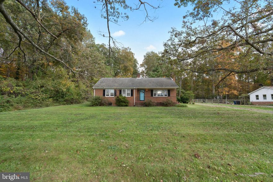 So much opportunity!! Well built all brick 3 bedroom 1-1/2 bath ranch on a fantastic 3 acre lot.  Partially wooded with mature hardwoods. 200'+ of vintage stone wall. 2 fireplaces (one with wood stove insert). Full walk up unfinished basement.  Full walk up floored attic for storage or potential for building a new upper level.  Home definitely needs updating and other work to make it your own... but can be wonderful.  Only 18 minutes to Leesburg.  Sold as-is.   Single family on 3 acres under $500K in Loudoun... won't last!  Crystal ceiling light fixtures in dining room, hall, foyer, and front 2 bedrooms do not convey.