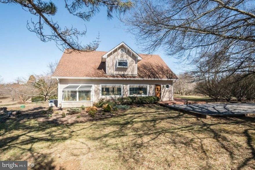 For the most discerning buyer with a VISION, opportunity abounds!  This property boasts gorgeous views at the end of a country lane.  Original 3-car garage carriage house was converted to a lovely home with 360 degree views atop a park-like knoll.  Live in comfort amongst 12+ acres of extremely serene surroundings and perhaps seize the opportunity to build an addition or larger dream home on the site.  Enjoy tranquil views from the maintenance free deck.  Gorgeous custom touches: quarter-sawn oak floors, stained glass, and picture windows fill the home with light.  Existing home can easily be converted back to a 3-car garage with in-law or au pair suite above.  Conventional gravity-fed 4-bedroom septic already installed.  Two wells on property (1 for home and 1 for irrigation).  Irrigation well includes multiple pumps set-up along the perimeter of the property with hose hook-up to care for the multiple groves of trees, orchards, berry bushes and more! Property is zoned AR-1 and 8 acres are in land-use (seller not responsible for roll-back taxes).  Golf cart and zero-turn mower included with sale.  Located just 20 minutes from Leesburg, 55 minutes from DC, and just 4 miles from the MARC train for a simple commute or escape from the city.  Easy access to shopping & fine dining (Patowmack Farm is minutes away).