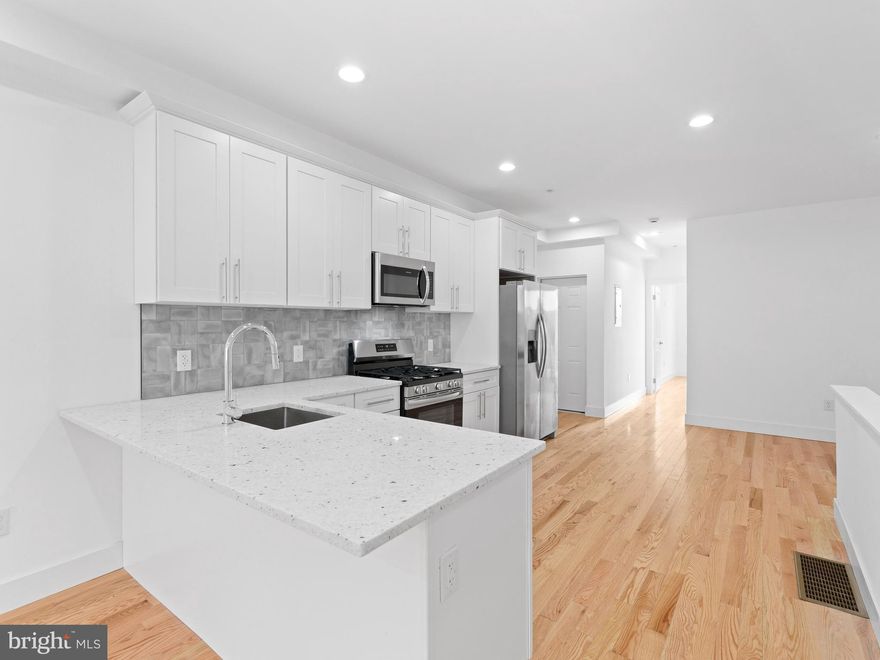 Be the first to call this exceptional, newly constructed 3-bedroom, 3-bathroom apartment in Overbrook home, Introducing 6442 Lansdowne Ave - Unit 1. This modern residence showcases a contemporary design with impressive high ceilings, stylish recessed lighting, and beautiful hardwood flooring throughout. The brand-new kitchen is a focal point, featuring a convenient breakfast bar, chic white shaker cabinets, elegant quartz countertops, and a full suite of new stainless steel appliances. Retreat to the modern spa-like bathrooms, equipped with an oversized shower for ultimate relaxation. This unit also offers generous closet space, the convenience of an in-unit washer and dryer, and the added benefit of a private parking spot in the rear. Enjoy a prime location near City Ave and the expressway, providing swift access, including a 15-minute drive to the scenic Kelly and Lincoln Drives. Embrace an active lifestyle with nearby bike trails and a golf course, and take advantage of the close proximity to diverse restaurants and shopping options. Commuting is a breeze with easily accessible train and bus lines. Schedule your private tour today!