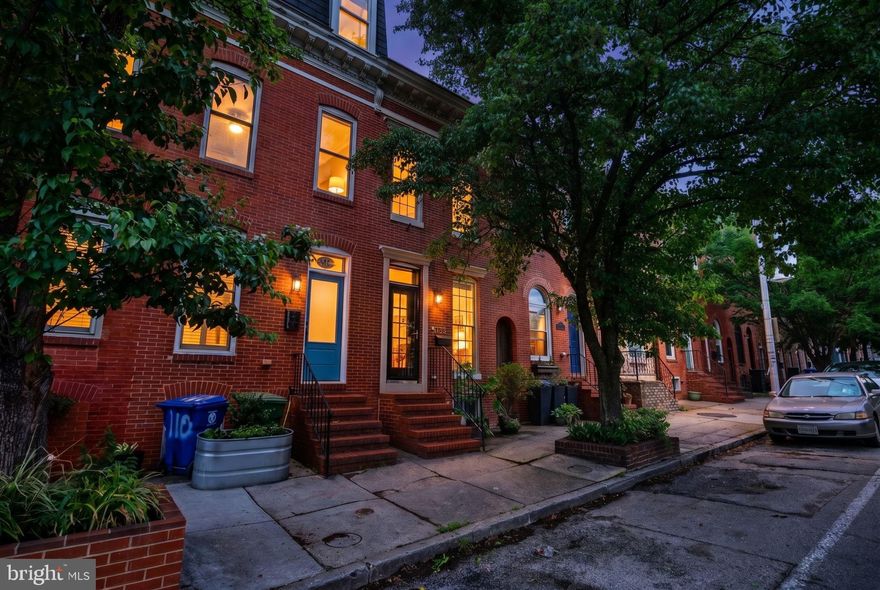 Welcome to 112 E Fort Ave, a remarkably well-maintained 2bd/2.5ba home with an oversized garage for dedicated off street parking! Brimming with charm, this Federal Hill rowhome offers hardwood floors, a spacious kitchen, rooftop deck and finished basement! The main level is open and is accented by an original fireplace, dental trim molding, a tray ceiling, exposed brick wall and a custom built-in for all of your storage needs. The windows pour in natural light, and there's plenty of space for all of your entertaining needs. The kitchen is spacious and provides ample prep space, granite countertops, stainless steel appliances and custom glass cabinets. The dedicated dining area is anchored by a custom glass slider to create al fresco dining! Upstairs offers a spacious primary bedroom with high ceilings, a large closet and exposed brick wall, plus a guest bathroom with large tub and large vanity for all of your storage needs. The rear bedroom is perfect for guests, a nursery or home office and offers an en suite bathroom with dual vanity, stall shower and a second jetted tub. Plus, the upper level offers access to laundry, a rare amenity in historic Baltimore homes. There is hallway access to the rooftop deck, which offers stunning views of the Baltimore skyline. The basement offers an additional finished space and could be a perfect home office, gym or play space. Recent upgrades include a full waterproofing/French drain system (2018), a basement remodel (2018), HVAC and water heater (2018), custom sliding glass door, and roof recoating (2026). Located just blocks from the famous Cross St Market and all of the nightlife Federal Hill has to offer, plus just a few blocks from scenic Riverside Park. If you are looking for a spacious home in the heart of Federal Hill with a dedicated garage, look no further!