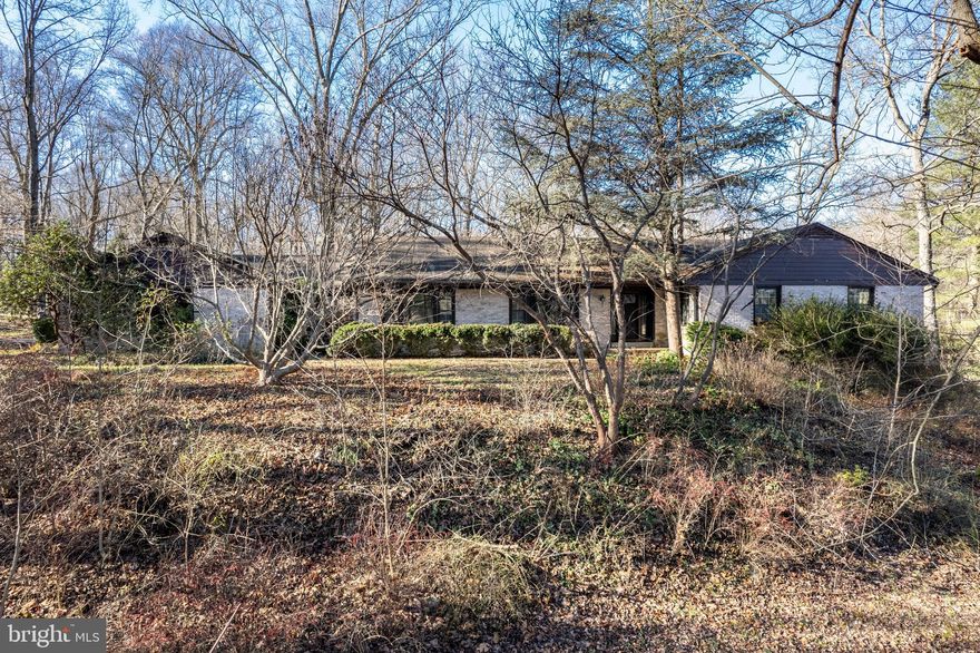 This one-of-a-kind, custom-built, all-brick rancher is a true gem, nestled atop a scenic hill on over 7 wooded acres, backing to Patuxent River State Park.  This  one owner home offers an unmatched combination of space, functionality, and charm.

Step inside to discover an updated kitchen featuring granite countertops and stainless steel appliances, seamlessly flowing into the cozy family room with a wood-burning fireplace—perfect for gatherings or quiet evenings. The home also boasts a large living room and formal dining room, ideal for entertaining or special occasions.

The spacious primary suite offers privacy with an en-suite bath, while three additional large bedrooms on the main level provide plenty of flexibility. The finished basement adds even more living space with a fifth bedroom, a full bath, a generous recreation room, and a utility room.

The breezeway leads to an oversized two-car garage, offering convenience and additional storage. There is an additional two car garage.  Outside, the sprawling property provides endless possibilities—whether you’re enjoying the wooded views, creating outdoor retreats, or exploring the surrounding Park.

This home is a rare find, offering privacy and nature while still being close to Washington DC.