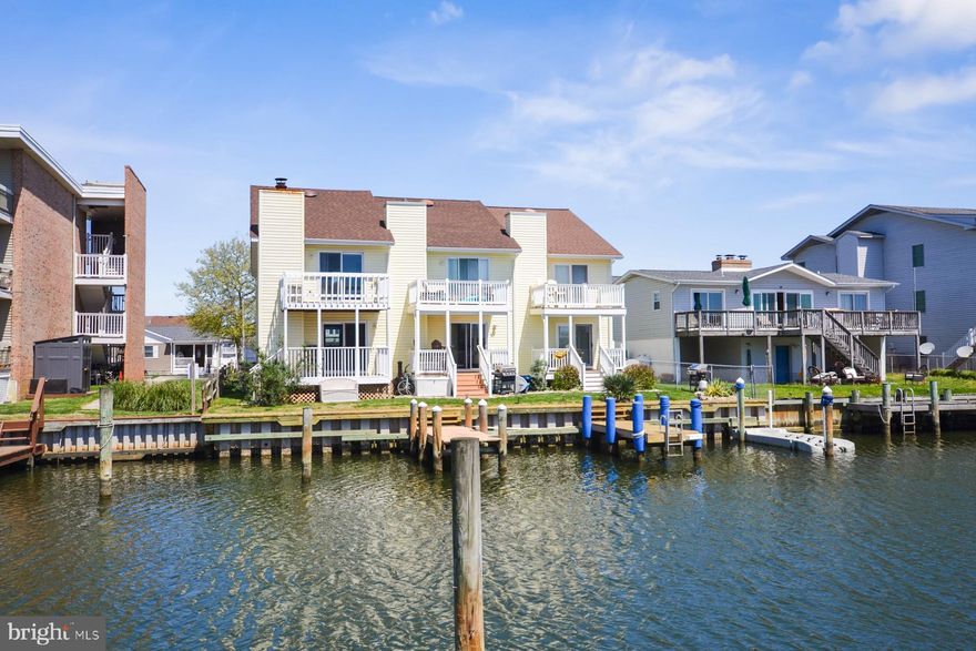 Experience waterfront living without the hassle of condo or HOA fees in this end-unit townhome, located in a quaint three-unit community. Recently updated with a newer roof, siding, exterior painting, sliders, doors, and windows, this home is move-in ready. The newer bulkhead adds further allure for boating enthusiasts.   Inside, the home features an inviting open layout that connects the living, dining, and kitchen areas, highlighted by expansive sliding glass doors that showcase breathtaking canal views and flood the space with natural light. The kitchen, complete with a breakfast bar, is perfect for casual dining or entertaining while enjoying the picturesque backdrop of boats gently passing by. Upstairs, two spacious bedrooms each boast ensuite bathrooms and ample closet space. The owner's suite is a retreat in itself, with sliding glass doors that open to a private balcony overlooking the serene waters.  Step outside onto the back deck or the upstairs balcony to truly appreciate the waterfront lifestyle. Start your mornings with coffee as you watch the sunrise and unwind in the evenings with a glass of wine, taking in the peaceful surroundings. This townhome also includes a private boat slip, providing direct access to the water for fishing, cruising, or simply enjoying the waterfront.  Conveniently located near the beach, dining, shopping, and entertainment, this property is ideal for year-round living or as a vacation getaway. Don’t miss this opportunity to own a piece of paradise in Ocean City, Maryland. Schedule your showing today and start living the coastal dream!