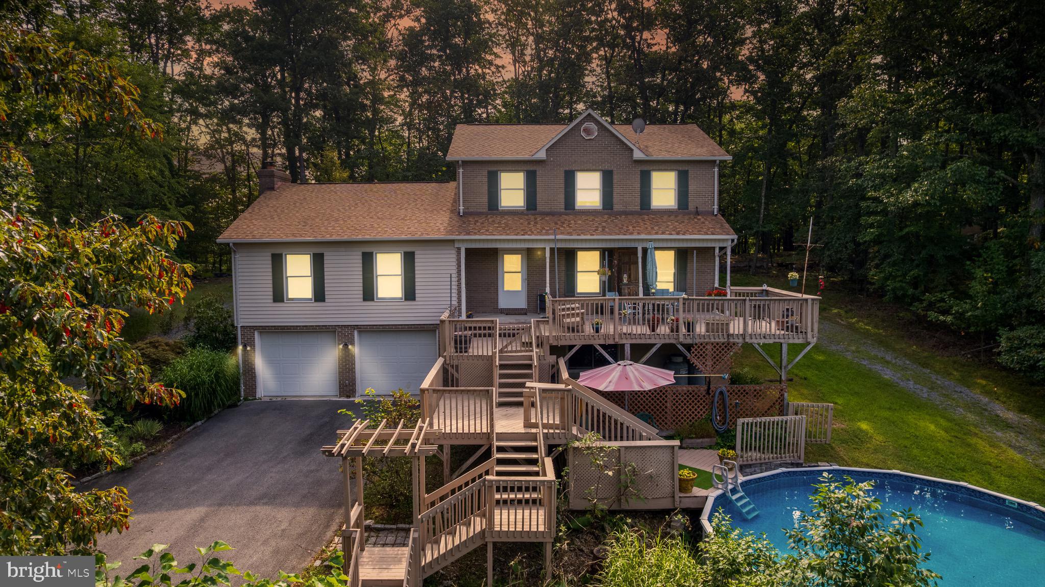 Welcome to your private retreat in Hedgesville, WV! Nestled on a wooded lot with its very own approx. 1-acre pond, this spacious two-story home blends peaceful country living with modern comfort.
Inside, you’ll find a bright and inviting living room, a formal dining space with hardwood floors, and a functional kitchen ready for your favorite recipes. Multiple bedrooms, including a generous primary suite, provide plenty of space, while additional living areas offer flexibility for home office, recreation, or guest use.
Step outside to enjoy everything this property has to offer. A large multi-level deck overlooks the above-ground pool—perfect for entertaining or relaxing on warm summer days. Multiple balconies and sitting areas create ideal spots to take in the serene wooded surroundings. And just beyond, the pond offers fishing, wildlife watching, and year-round natural beauty right in your backyard.
Additional features include an oversized two-car garage, a detached storage shed, and a long driveway with ample parking. Mature trees and landscaping provide shade and privacy, while the home’s location keeps you close to Berkeley Springs, Martinsburg, and commuter routes.
This property is being sold as-is, offering an excellent opportunity for buyers to customize it to their vision. With a pool, pond, and peaceful setting, it’s a rare find in Hedgesville. Schedule your showing today!Buyer to do due diligence regarding all measurements, square footage, and property details.