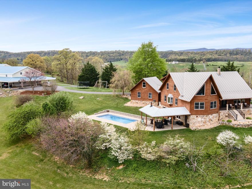 LOOKING for a gorgeous 87 acre Horse Farm located in the Shenandoah Valley?  Welcome HOME! This 4000 +/- sq ft Custom built log home is perfectly situated with amazing mountain views of the Shenandoah Valley!  This UNIQUE  4 bed/3.5 bath home boasts amazing top notch craftsmanship throughout using many materials produced straight from the property including the  Chert-Stone foundation, Radiant heated wood floors on the main level, a handcrafted Tulikivi  (Swiss) Soapstone wood-stove/fireplace, loft w/2 bedrooms, home office off of the eat in kitchen/dining room boasting custom Black Cherry kitchen cabinets, stainless steel appliances, gas cooking, indoor pizza oven, hardwood floors throughout, cathedral ceilings, spacious rooms w/primary owners suite on the main level, updated bathrooms, whole house generator,  brand new partially finished bottom level with home gym, full bath/bedroom that offers walkout to your Saltwater swimming pool, firepit & outdoor cooking area for entertaining! There is a connected 2 car garage & a private gated paved driveway to the home. The Farm offers 2 barns  one has 4 stalls, full bath, professional workshop/garage section attached barn, overhang for horse trailer, feed room, tack room, washrack (not in use), jump field, RV hookup, & a huge equipment/hay storage building near 2nd barn. The second barn offers 4 stalls and  an open inside area that can be used to add on additional stalls.  The land is approximately 50 acres of fenced pasture/ hay fields as well as approximately 38 acres of predominately mature hardwood forest, including a perennial stream & a pond! Hours of hacking out/trails on the property. Starlink high speed internet ! 
Location offers  hiking, biking, trail riding, museums, vineyards, local shoppes, appx 15 min from Bryce Ski Resort (winter/summer fun), & highway 81 for commuters., 1.15min to Lexington Horse center,  & 30 minutes to JMU.  Best use for this farm is equestrian, vineyard, wedding venue, vacation home or private estate. Professional photos coming soon! Make your appointment today!