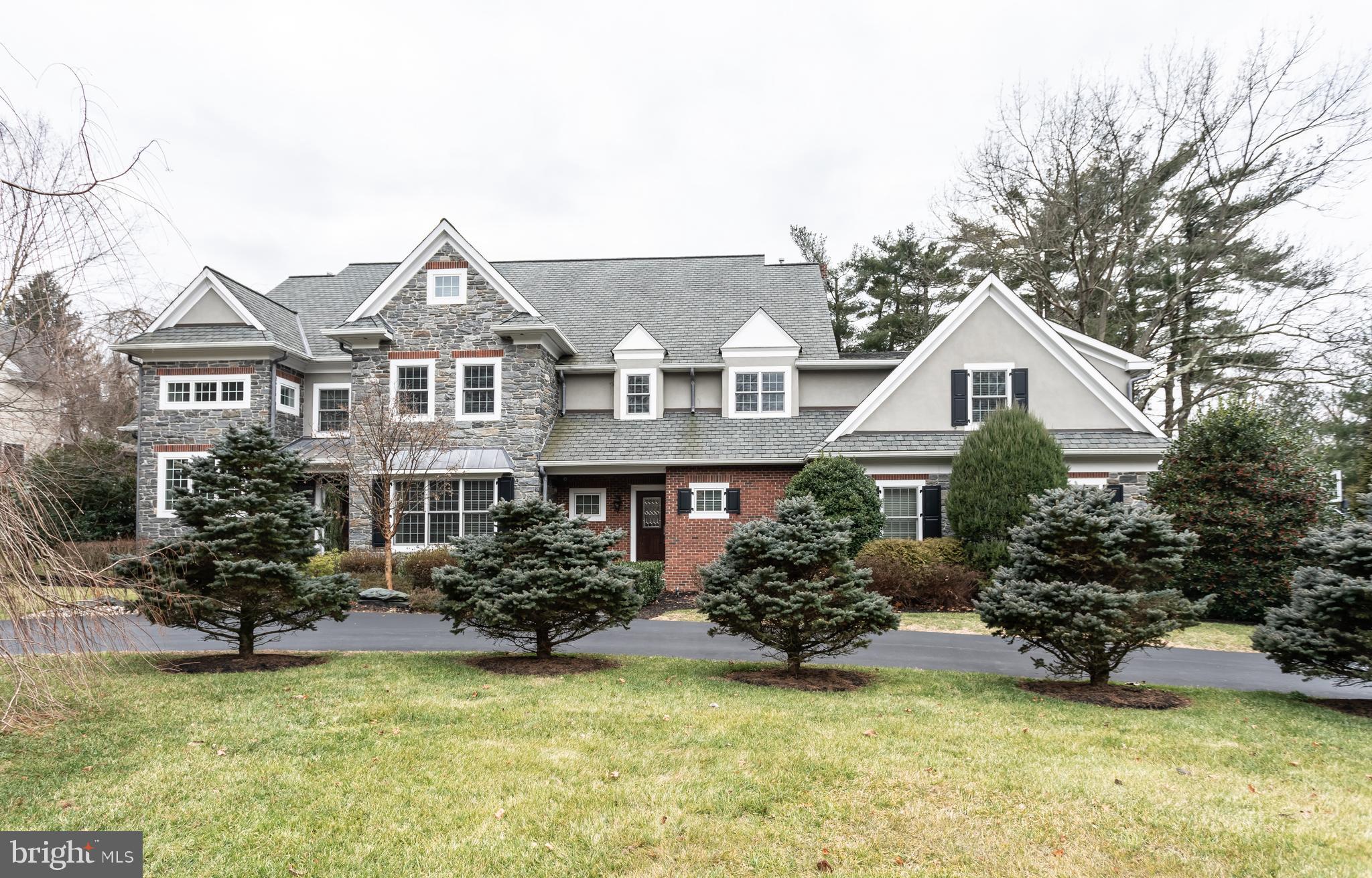 904 Wootton Road, Bryn Mawr, is an exceptional manor house with ELEVATOR that features superior construction with the finest materials. 10ft. ceilings, custom millwork, an all-floor elevator, a pizza oven and a whole-house generator are just some of the luxuries awaiting you. Situated in Radnor Township with a flat lot, this 5 bedroom home with finished walk-out Lower Level is a show stopper. The first floor includes hardwood floors throughout, elegant dining room and living room with gas fireplace, study with built-ins, 2 half baths, and a cozy family room with coffered ceiling and gas fireplace. The eat-in gourmet kitchen is a chef's dream, featuring reclaimed barn wood flooring, a huge center island, light custom cabinets, granite countertops, high-end appliances, two dishwashers and a brick pizza oven. The second level boasts hardwood flooring throughout, 5 bedrooms and 5 bathrooms. The luxurious master suite includes a large master bedroom with vaulted ceiling, his-and-hers walk-in closets AND his-and hers separate, full bathrooms. There are two additional bedrooms with en-suite bathrooms and 2 bedrooms that share a jack-and-jill bathroom with convenient second floor laundry room with cabinetry. The fabulous walk-out lower level is an entertaining haven! Large rec room with fireplace, exquisite state of the art wine cellar, built-in wet bar and huge gym with bath. A four car HEATED garage completes this incredible home. Public water & sewer and 4 zone heating/cooling. The exterior of the home is solid gray Mica stone with gorgeous brick inlay. (No stone facade here!) The rear boasts a covered outdoor living room and bluestone patio, perfect for entertaining on a warm day! Better than new construction with the lower level already finished and professional landscaping with specimen plantings like a gorgeous Magnolia tree. Move right in! Amazing Radnor schools and close to many private schools. *Please note that Delaware County is conducting a real estate tax reassessment, effective January 1, 2021. If you have any questions or concerns about the impact of this process on the future real estate taxes for this property, you should contact the Delaware County Treasurer's Office.