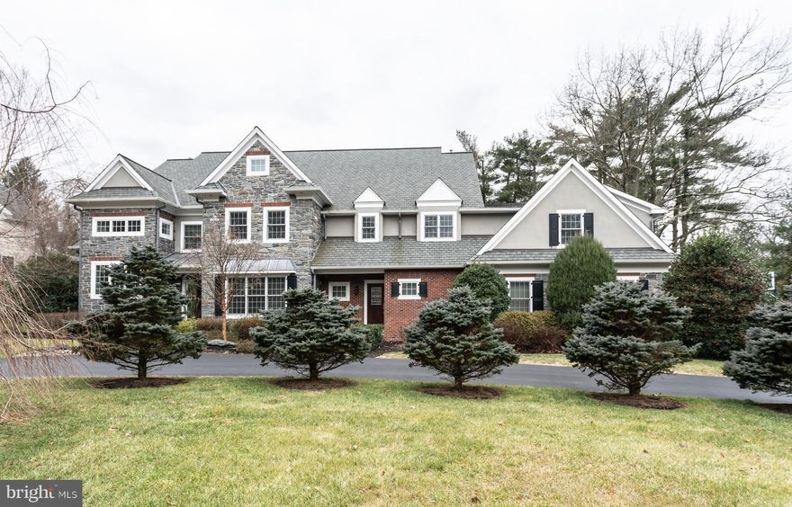 904 Wootton Road, Bryn Mawr,  is an exceptional manor house with ELEVATOR that features superior construction with the finest materials.  10ft. ceilings, custom millwork, an all-floor elevator, a pizza oven and a whole-house generator are just some of the luxuries awaiting you.   Situated in Radnor Township with a flat lot, this 5 bedroom home with finished walk-out Lower Level is a show stopper. The first floor includes hardwood floors throughout, elegant dining room and living room with gas fireplace, study with built-ins, 2 half baths, and a cozy family room with coffered ceiling and gas fireplace. The eat-in gourmet kitchen is a chef's dream, featuring reclaimed barn wood flooring, a huge center island, light custom cabinets, granite countertops, high-end appliances, two dishwashers and a brick pizza oven. The second level boasts hardwood flooring throughout, 5 bedrooms and 5 bathrooms. The luxurious master suite includes a large master bedroom with vaulted ceiling, his-and-hers walk-in closets AND his-and hers separate, full bathrooms. There are two additional bedrooms with en-suite bathrooms and 2 bedrooms that share a jack-and-jill bathroom with convenient second floor laundry room with cabinetry. The fabulous walk-out lower level is an entertaining haven! Large rec room with fireplace, exquisite state of the art wine cellar, built-in wet bar and huge gym with bath. A four car HEATED garage completes this incredible home. Public water & sewer and 4 zone heating/cooling. The exterior of the home is solid gray Mica stone with gorgeous brick inlay. (No stone facade here!) The rear boasts a covered outdoor living room and bluestone patio, perfect for entertaining on a warm day! Better than new construction with the lower level already finished and professional landscaping with specimen plantings like a gorgeous Magnolia tree. Move right in! Amazing Radnor schools and close to many private schools.  *Please note that Delaware County is conducting a real estate tax reassessment, effective January 1, 2021. If you have any questions or concerns about the impact of this process on the future real estate taxes for this property, you should contact the Delaware County Treasurer's Office.
