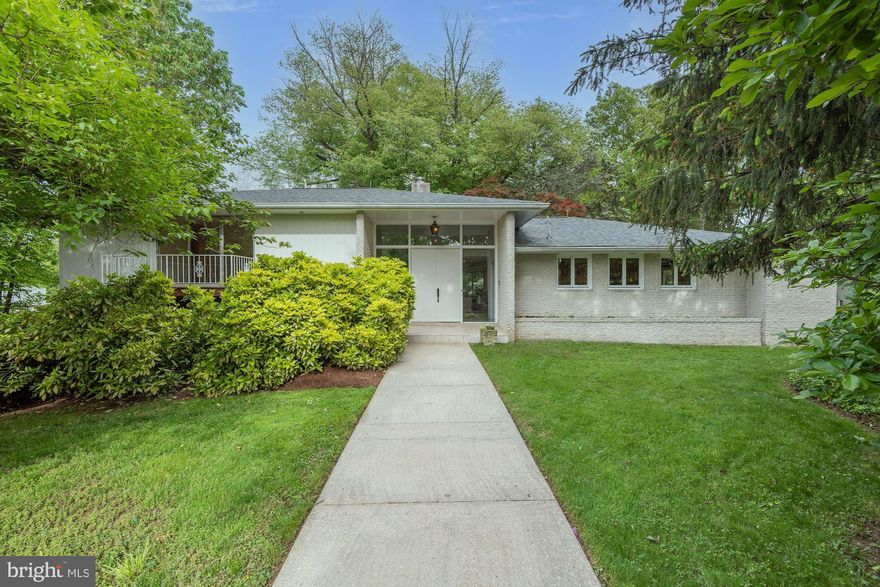 Accessed via Blackthorn St & Alley and situated on a charming English courtyard, this rare 5BR/5.5BA contemporary has been enjoyed by its current owners for 30 years. Majestic trees, mature shrubbery, and vibrant ivy adorn the lovely .31-acre lot which offers generous space for lawn expansion. Composed of beautiful white brick, the front elevation boasts tall double entry doors with sidelights, an integrated window box, and a balcony. The spacious interior offers an open floor plan nicely distributed over 4 split living levels while lush views through oversized windows bring the beautiful outdoors in. A fresh neutral paint palette, golden hardwood flooring, and translucent Shoji sliding doors create harmony throughout. Main level highlights include an airy entry foyer, a stunning connected living and dining room with patio access, a granite/stainless kitchen with a breakfast area, and a powder room. Off the lower foyer is a large family room with one of two fireplaces, a full bath, and a laundry room. On the upper level is a private generous owners’ retreat with a luxurious bathroom and walk-in closet as well as two additional bedrooms and a stylish updated hall bathroom with steam shower. Above grade on the east side, the wonderfully versatile lower living level offers multiple work-study areas, a recreation room, a bedroom with an en-suite bathroom, and a separate apartment with sitting room, kitchen, and an office all of which are well suited to a home practice or multi-generational living. An attached rear loading 2-car garage, a new roof, and a newer AC unit round out the package. Close to country clubs, downtown Bethesda, Washington DC, and major travel routes, this location is ideal! *Elementary Schools: Rosemary Hills (PreK-2nd); Chevy Chase (3rd-5th)*.