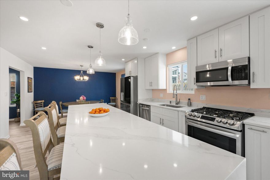 Welcome to 1925 N. Westmoreland Street, a 4BD/3.5BA home offering abundant natural light, thoughtful design, and effortless flow throughout. At the heart of the home is the spacious, sunlit kitchen, featuring crisp white cabinetry, quartz countertops, a striking oversized island, stainless steel appliances, and a thoughtfully designed wet bar with wine fridge and custom bench seating. The kitchen/dining room combination creates an ideal layout for everyday living and entertaining, and also provides easy access to the back patio for seamless indoor-outdoor enjoyment. The adjoining living room offers an inviting wood-burning fireplace and a convenient powder room completes this level.

Upstairs, the expansive primary suite includes an ensuite bath, a generous closet, and a versatile bonus room well-suited for an office, yoga studio, or quiet retreat. Two additional bedrooms and a well-appointed hall bath complete the upper level.
The fully finished lower level provides exceptional versatility for recreation and guests. It features a second fireplace, a full bathroom, laundry room and an additional bedroom.
The attached two-car garage offers space for storage and a dedicated workshop area, complete with a metal pegboard for tools and a 240-volt circuit. Outside, the fully-fenced backyard offers privacy and serenity, highlighted by a professionally designed stone patio with seating wall perfect for dining al fresco. The landscaped cottage gardens feature crepe myrtle trees, climbing roses, and hundreds of spring-blooming bulbs.
This home’s location is truly exceptional: just an 8-minute walk (or 2-minute drive) to the East Falls Church Metro on the Orange and Silver Lines, one block to local shops and dining, and across the street from Isaac Crossman Park with easy access to the Four Mile Run Trail. This home offers the perfect blend of style, comfort, and convenience. Welcome home!