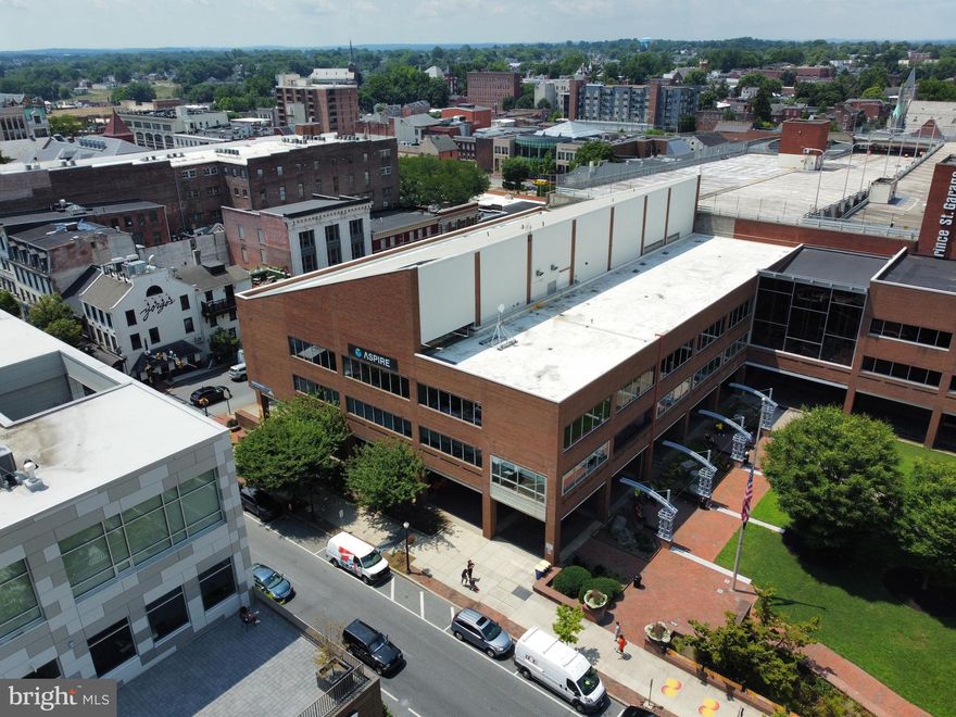 ICONIC PROPERTY in Downtown Lancaster for Owner-Occupant or Investment (projected 7% CAP Rate). 
This landmark 3-story brick building plus finished lower level features elevator access to all floors, direct interior connections to the Prince Street Parking Garage, expansive windows, private outdoor space by Binn's Park, indoor/outdoor atrium, custom upgrades, CAT 6 wiring, fob-secured access, auditorium and more.  Ideally located one block from Penn Square in the heart of Lancaster City — walkable to the courthouse, Gallery Row, restaurants, hotels and entertainment. 99/100 Walk Score with signage exposure to over 20,000 vehicles per day. The building totals 77,294± SF (62,325± SF above grade) and is zoned CB1. Take advantage of the CRIZ tax, grants and loan incentives. Investor upside potential after lease-up at market rates. Alternatively, the flexible layout, first-floor retail potential and Class A finishes make it well-suited for an owner-occupant seeking a flagship headquarters in an unbeatable downtown location.