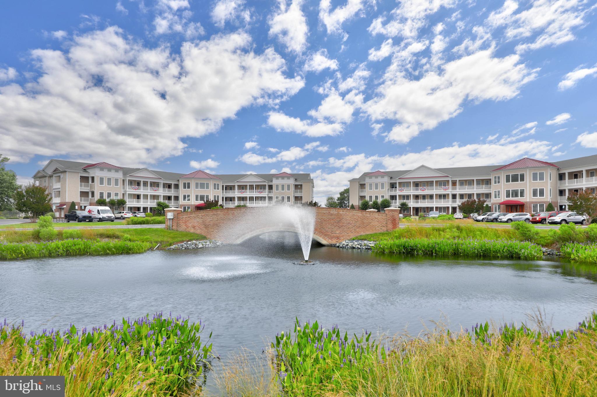 Welcome to the stunning "pivot" condo, located in the waterfront Points Reach community of Ocean Pines, Maryland. This exceptional corner unit is renowned for its spaciousness, offering one of the largest floor plans in the community. As soon as you step inside, you'll be greeted by a large and welcoming foyer that sets the tone for the luxurious living spaces that lie beyond. As you enter the living room, stunning panoramic views opens up displaying a landscape of the bay that greets you through multiple large picture windows, truly showcasing the beauty of the waterfront setting. This expansive living space provides a perfect space for relaxation and entertaining with the abundance of natural light that floods the room creates an inviting and airy atmosphere. The kitchen is a great complement for entertaining, featuring a center island and peninsula island breakfast bar, providing ample counter space for meal preparation. Solid surface counters and stainless-steel appliances add a touch of sophistication, while the open layout allows for seamless interaction with the adjacent spacious dining room. Whether you're hosting an intimate dinner or a festive gathering, this space is sure to impress. One of the standout features of this condo is the multiple balconies that overlook the water. Step outside onto these private retreats and immerse yourself in the serene surroundings, enjoying the gentle breeze or an outdoor meal cooked on the built-in grill. It's the perfect spot to relax, unwind, and soak in the beauty of the bay. The waterfront primary suite is a true oasis, boasting personal balcony access and an attached lavish bath. This relaxing full bath features double sink vanities, a soaking tub, a spacious shower, and double walk-in closets, providing a serene and luxurious retreat after a long day. Two additional bedrooms share a well-appointed bathroom on the opposite end of the unit, offering privacy and comfort for family members or guests. Additionally, there is a study or office space with tranquil waterfront views, providing an ideal setting for work or relaxation. Living or vacationing in this breathtaking condo offers an exceptional lifestyle in the coveted Points Reach community. With its corner location, panoramic bay views, spacious living areas, and luxurious amenities, this condo truly embodies the essence of coastal living at its finest. Condo fee covers insurance, exterior maintenance, landscaping, twice yearly inspections on the geothermal system, fireplace and outdoor grills, annual inspection on fire sprinkler system, biannual cleaning of the dryer ducts, & sewer. Low utility bills average $100 monthly and water runs $51 quarterly.