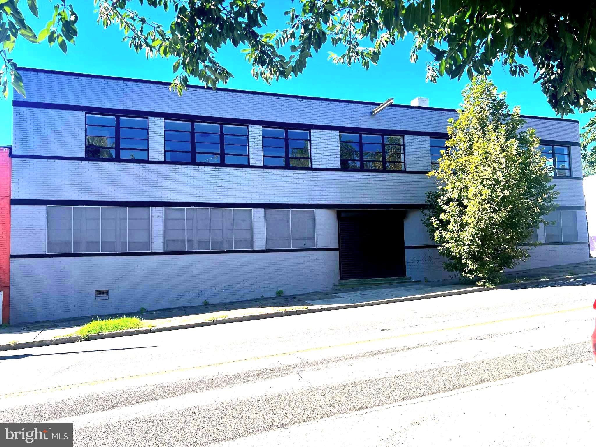 Owner Operated/Investor Opportunity. Fully renovated in July, 2025. Zoned I-1, industrial flex warehouse building. 2 levels, +/- 14,368 sq ft finished space situated on a fully fenced 0.42 ac lot. Inside the rear metal gate entrance are ample car parking spaces with 2 trailer spaces and a large detached storage space. The back entrance to the building from Hollins St has one loading dock and wide doors that lead to a huge open warehouse space, gas heating furnace, water heater and half bath. Portable A/C units on main level. Three additional warehouse spaces on left. On the right, there are more separate spaces with access to the basement, a second half bath and a second heating furnace. The front entrance from W Baltimore St is at a garage door and a double door that leads to lobby space and kitchenette area. on either side of the front entrance are two spacious areas for office use overlooking W Baltimore St with secured glass windows.
Two stairways to the Upper Level, one at the rear entrance and the other from the lobby area. Upper Level has a huge open space that runs along W Baltimore St with windows for the entire width of the building. Another spacious open space runs along S Catherine St. There is a third half bath at this level.
The building has an excellent location close to Grace Medical Center, University of Maryland Medical Center, Port of Baltimore and BWI Airport. I-1 zoning has myriad uses. Please verify with Baltimore City zoning for your specific use.