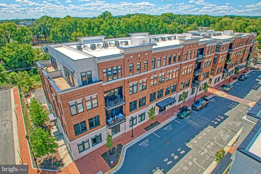 $10,000 BUYER CREDIT TOWARDS CLOSING COSTS!  Motivated Sellers!
Experience refined, single-level living in Historic Downtown Leesburg’s premier King Street Station, where boutique sophistication meets effortless comfort. Positioned at the quiet end of the community, this residence blends timeless elegance with modern convenience, creating a sanctuary designed for today’s discerning buyer.
Step inside to discover an open-concept kitchen, dining, and living area, where natural light streams through tall windows enhanced by Hunter Douglas Duette® Honeycomb Shades. Soaring 10-foot ceilings, upgraded wide-plank hardwood flooring, and designer lighting on dimmers create a warm yet polished ambiance. A gas fireplace with remote control serves as a welcoming focal point, ideal for both cozy evenings and entertaining with friends.
The gourmet kitchen is a true showpiece, offering a spacious center island, upgraded soft-close cabinetry with customized interiors, under-cabinet lighting, Silestone countertops with matching backsplash, and a suite of KitchenAid appliances—including a five-burner gas cooktop and French door refrigerator. Thoughtful touches extend throughout, from Elfa custom closets to a highest-capacity LG washer/dryer with a utility sink and sprayer. Tech-savvy buyers will appreciate wired ethernet drops in every room, Ethernet hookups in living and bedroom spaces, and whole-home smart upgrades for effortless connectivity.
Everyday living is enhanced with advanced features—Flair automated HVAC vents, a Nest thermostat, whole-home filtration and humidification systems—all designed for comfort and efficiency. The private garage with keypad entry includes Elfa shelving, and the driveway provides parking for a second car.
Outdoors, a gracious balcony with self-watering window boxes, waterproof outlets, and remote-controlled lighting sets the stage for al fresco dining. A high-end Kenyon Frontier electric grill with digital controls and full grill cart conveys—inviting you to enjoy wine country evenings under the glow of café lights.
Beyond your front door, morning coffee at GooseCup, strolls along the W&OD Trail, and boutique shopping and dining await just steps away. Manicured community plazas and pavilions add to the appeal, while quick access to Route 7, the Dulles Greenway, and Dulles Airport ensures seamless connectivity. With the new Burg Hotel and Leesburg’s vibrant culinary scene nearby, every indulgence is within reach.
Sophistication, convenience, and lifestyle converge here—making this King Street Station residence a truly rare offering in the heart of historic downtown.