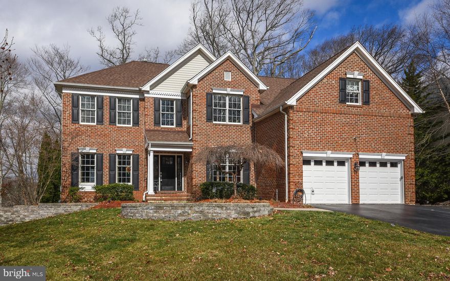 Pride of ownership is apparent in this stunning two story brick front luxury home! Custom walkway and new front entry door lead to an open two-story foyer with circular staircase. Beautiful hardwood floors throughout the first floor create a cohesive flow.  The Living Room and Dining Room span the left side of home and offer alluring hardwood flooring, triple crown molding, upgraded lighting, and chair rail. . Perfectly located on the first floor right corner  is a private spacious office for working from home or a perfect spot for a cheery playroom with glass French Doors. Light filled kitchen s open design makes the Professional Chef kitchen extended by five feet at construction, with abundant and upgraded 42 inch maple cabinets, hardwood flooring, stainless appliances including Electrolux double wall oven, high end five burner Gas Stove, exhaust fan, Electrolux refrigerator, GE #1 model dishwasher, granite countertops, granite topped island featuring prep sink with an insinkerator, under lighting on cabinets, Grohe faucet, and enlarged breakfast room with custom built-in Butlers pantry for additional storage. New energy efficient sliding glass doors lead to extended west facing maintenance free rear deck built with a no screw fastener system outlining the rear of the home overlooking picturesque private rear yard. Ground behind home is protected and will remain private and open.  The rear yard ends at landscape line.  Location of this home is a definite upgrade. The Weber Genesis Gas Grill with natural gas line is included with the home. The expansive family room (5 feet added) has a two story ceiling, built-in bookshelves with the focal point of the room being the stone fireplace which has a new hearth and insert. Beautiful rear window seat accents the room.Powder Room is in the front hallway. Laundry Room has been equipped with built in closet organizer for coats and shoes and additional storage over washer and dryer is located on your path to two plus car front garage. The three car garage has parking for 2 cars diagonally and one car horizontally. New upgraded garage doors with state of the art quiet garage door openers. The Master Suite is designed to be your oasis with a sitting area, organized extensive walk-in closet, extensive master bath double vanity, double stall shower with double shower heads are six inches higher than standard, tub, and upgraded lighting and new sliding glass shower doors. A Jack and Jill bathroom is shared by two of the bedrooms. The Fourth bedroom has a private bathroom. All bedrooms have built in closet organizers, and all shower heads are six inches higher than standard. Finished basement is equipped with a theater room, powder room and open area perfect for a game room and computer area. Additional entrance to the rear yard through new sliding glass doors. There is abundant additional storage in the basement. The two zoned HVAC system is 4 years old and under a ten year parts and labor warranty. There is a new water softener, new front door, and new lighting on the exterior. The roof was recently cleaned and gutter guards are installed in the gutters. The property has an electronic dog fence around the perimeter of the property. The radon mitigation system was installed recently-documentation is available. Home has had stucco repair work completed and reports are available for review along with home inspection report.