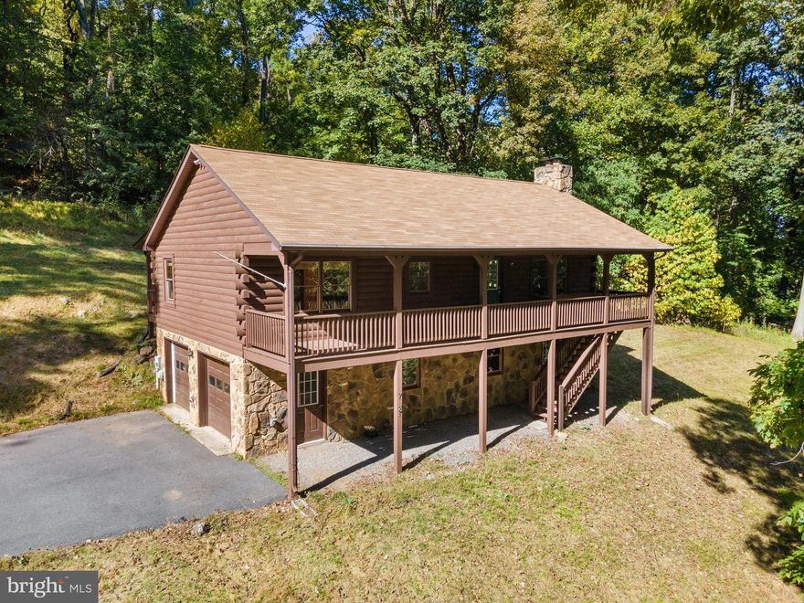 Nestled within a serene forest canopy, this exquisite log and stone home offers unparalleled privacy and rustic elegance. A harmonious blend of natural materials and modern amenities, this property is a true gem, boasting a single-level design with high vaulted wood ceilings and a spacious full basement with a rear walkout. This tranquil sanctuary beckons those seeking a peaceful, nature-inspired lifestyle.

Interior highlights:
Expansive family room: Step inside and be greeted by a warm and inviting family room adorned with a majestic stone wood-burning fireplace, providing the perfect setting for cozy evenings and gatherings with loved ones. The soaring vaulted wood ceilings enhance the sense of space and grandeur.

Open-concept living: The open layout seamlessly connects the family room to the dining area and kitchen, fostering a sense of togetherness. 

Restful Bedrooms: Two well-appointed bedrooms offer comfort and tranquility, while large windows invite natural light and views of the surrounding woods as well as ample closet space!

Convenient amenities: The separate laundry room provides convenience and functionality, simplifying daily tasks.

Outdoor oasis:
Surrounded by nature's beauty, this home invites you to savor the great outdoors from multiple covered porches that encircle the property. Whether you're enjoying your morning coffee, hosting an alfresco dinner, or simply soaking in the sights and sounds of the forest, these spaces are perfect for relaxation and rejuvenation.

Additional Features:
Two-car built-in garage for secure parking and storage.
A full basement, insulated and awaiting your personal touch, offers the potential for expanded living space, a recreation room, or a workshop—let your imagination run wild.