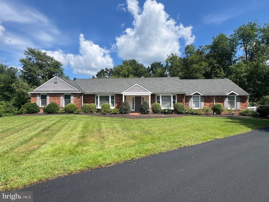 Welcome to this beautifully expanded and meticulously maintained ranch-style home, ideally located in the heart of Villanova, Radnor Township.  Situated down a long private driveway on 1.8 acres of professionally landscaped land, this home offers the perfect combination of privacy, luxury, and convenience. Step inside to a gracious foyer with gleaming hardwood floors, flanked by a formal living room and dining room, both filled with natural light. The foyer opens into a vaulted-ceiling great room with a stunning see-through fireplace, flowing seamlessly into the gourmet kitchen. The kitchen boasts a massive center island with natural wood block with bar stools and cabinetry, Corian countertops, and access to an enclosed screened porch/deck with skylights and breathtaking views which is ideal for everyday relaxing or entertaining. The bedroom wing features four spacious hall bedrooms with a beautifully updated shared bath, while the primary suite offers a peaceful retreat with sliding doors to the rear porch, ample closet space, and a luxurious en-suite bath with soaking tub, shower, and double vanity. Beyond the kitchen, a powder room, mudroom/laundry area, and access to the attached side-load 2-car garage—equipped with NEMA 14-50 240-volt outlet for electric car charging—offer everyday convenience.   The finished lower level is a true bonus—featuring a 5th bedroom and full bath, wet bar, family room, exercise room, game room, and plenty of unfinished storage. With daylight windows and outside access, it's perfect for an in-law or nanny suite. Additional features include gas heat, public water & sewer, a high-efficiency HVAC system, no HOA fees and low taxes ($14,917/year) Conveniently located minutes from train stations, major highways, Villanova university and all that the Main Line has to offer.  This is a rare opportunity along the main line.  Experience the best of all worlds, peaceful privacy, modern upgrades and a prime location.  Schedule your private showing today!