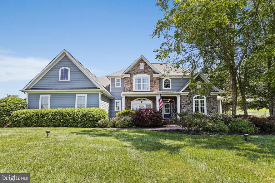 Welcome to this exquisite Mueller home, where every detail has been meticulously crafted to offer unparalleled luxury and comfort. As you step inside, you'll be greeted by the warmth of solid hardwood floors that grace the entirety of the first level, guiding you towards the heart of the home.

The grandeur of the two-story family room immediately captures attention, adorned with impressive built-ins, a coffered ceiling, and a striking stone front fireplace, creating a perfect ambiance for relaxation and gatherings. Adjacent lies the gourmet kitchen, a culinary haven boasting stainless steel appliances, quartz counters, and a propane gas stove, complemented by a wall oven, convection microwave, warming drawer, and a center island crowned with honed granite, ideal for culinary adventures and casual dining.

Nestled just off the kitchen, the breakfast bar and room offer ample space for family meals, while the attached Keeping Room invites quiet mornings with a cup of coffee beside the fireplace. The first-floor Owners’ Suite is a sanctuary of privacy and indulgence, featuring a spacious bedroom with a sitting area overlooking the serene back gardens. Luxuriate in the spa-like Owners’ bath, complete with a clawfoot tub, marble shower, and dual vanities adorned with lighted mirrors, while the walk-in closet boasts a thoughtful organization system.

For those who work from home, the generously sized office provides sweeping views of the front yard, ensuring a productive and inspiring environment. Upstairs, three guestrooms and two full baths offer comfort and seclusion for family and visitors, with a view overlooking the inviting family room below.

The lower level beckons with promises of entertainment and leisure, boasting a game room with a wet bar and wine fridge, an attached family room, and a home theater equipped with reclining seating and projection equipment for cinematic experiences. Additionally, a 5th bedroom/gym, full bath, utility room, and expansive storage space provide convenience and functionality.

Outside, the stone multi-level patio sets the stage for al fresco gatherings, complemented by a built-in grill surrounded by granite counters and an outdoor fireplace for cozy evenings. The oversized 2-car attached garage, complete with a rubber floor and car charger, ensures convenience, while the detached garage offers secure storage for additional vehicles and equipment.

Nestled within the desirable community of Pine Brook Farm, the 1.3-acre lot is meticulously landscaped and partially fenced, offering serenity and privacy amidst natural beauty. Welcome home to a lifestyle of luxury, comfort, and unparalleled elegance.