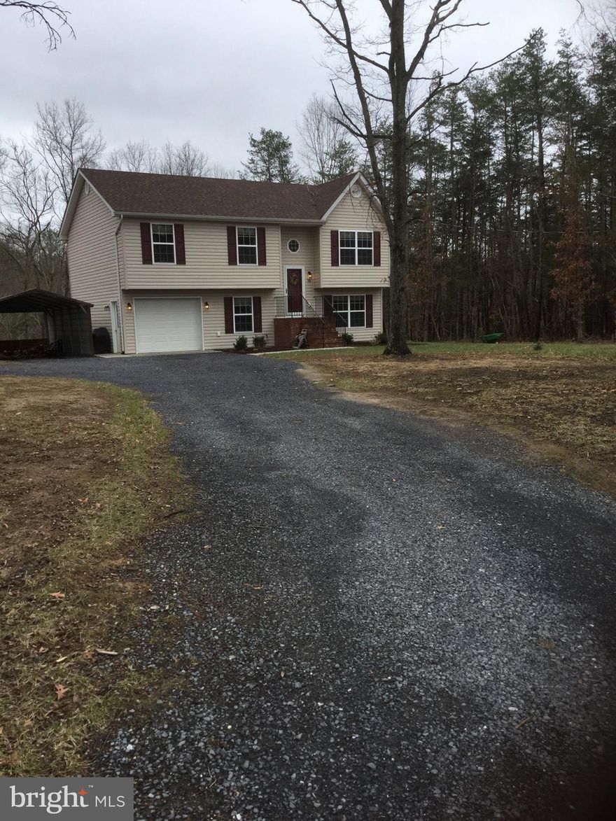 Private setting with this 3 bedroom split foyer on quiet cut-de-sac.  Level yard with outdoor fire pit.  Carport and basement garage.    Basement area framed out with rough-in plumbing ready to finish.  Workshop area in basement. Lot is approx 1.45 acres