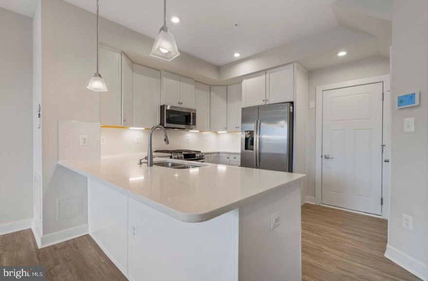 Two-level lower condo offering 1,608 sq ft of living space with an attached rear-entry one-car garage and opener. The second level features three generously sized bedrooms and two full bathrooms. The main level showcases beautiful flooring throughout, stainless steel appliances, and quartz countertops. The primary suite includes his-and-her walk-in closets. Condo fee covers water and sewer. Blinds are on order, and a washer and dryer will be installed. Conveniently located just minutes from Dulles Landing shops and close to shopping, medical facilities, library, dining, and more. Easy access to Route 50, County Parkway, and the 267 Greenway/Toll Road, and near Dulles International Airport—combining style, functionality, and an exceptional location.