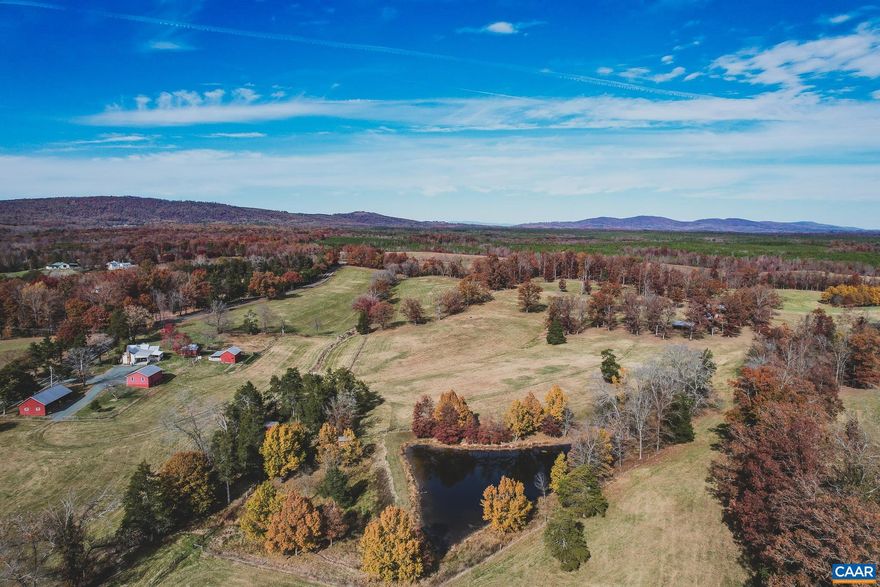 This is a beautiful and exceptionally located 75-acre property, less than 20 minutes from Charlottesville. This land boasts mountain views, 2 ponds, multiple out buildings and storage barns, fully fenced perimeters with cross fencing, rolling hills, mature hardwoods, and a 2 bedroom farm house. The property was a working farm for multiple generations, and now peacefully awaits the next owners. It is fully ready to accommodate horses, cattle, and any other homestead desires. There is plenty of storage for vehicles, hay bales, animals, or workshops. There are multiple waterers on the property connected to a well. The land is diverse, with oak trees scattered throughout the rolling hills and mountain views on the elevated knolls. There are also approximately 22 acres of hardwoods, with an abundance of wildlife including whitetail deer and wild turkey. Adding to the value of the property is that it is comprised of 5 adjoining parcels, allowing the next owners to either build additional primary residences and buildings for the family, or sell adjoining parcels for additional profit if desired. There is plenty of road frontage, with approximately 2,675 ft along Rolling Rd. Minutes from Monticello, Michie Tavern, and renown wineries.,Wood Cabinets,Fireplace in Living Room