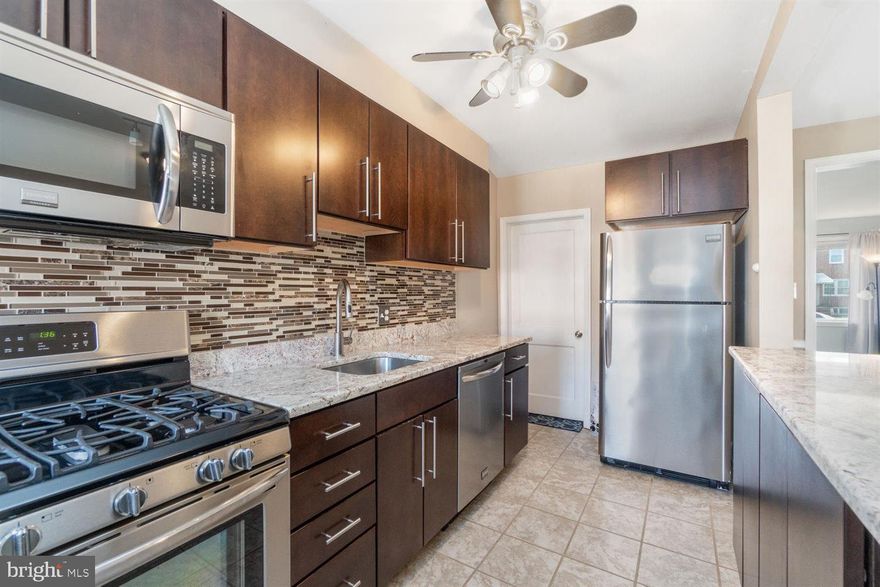 MULTIPLE OFFERS, BRING HIGHEST AND BEST BY 12/30/20. Perfect for 1st time homebuyer or investor. This 3bdrm 1.5bath town home is the perfect space! Beautiful gray laminate flooring on first floor (which can be removed at buyers request with gorgeous hardwoods underneath) Porch front/ updated kitchen w/ granite counters, backsplash, breakfast bar, s/s appliances & espresso finished cabinetry/ composite decking is low maintenance, rear parking, full basement w/ half bath & laundry area and walk out stair to patio-Lots of space to grow. Schedule your appointment today!!!