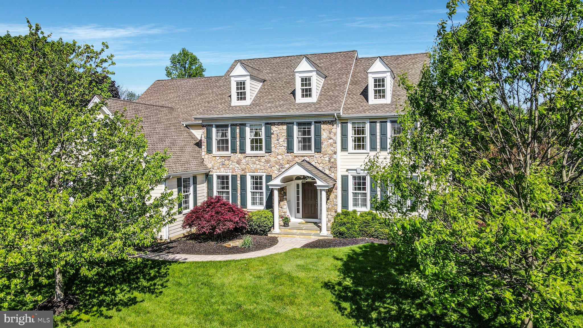 Welcome to 214 Sage Hill Lane, where modern living meets Chester County country charm. Situated on a tranquil cul-de-sac lane in the sought-after Sage Hill community, this classic yet contemporary estate home offers 5,000 square feet of living space, including 4 bedrooms, 3 full bathrooms with 3 half baths, and a finished basement. The spacious foyer invites you into a bright, warm atmosphere highlighted by wide-plank finished hardwood throughout the main living areas. The entranceway is flanked by the formal dining room and living room, each boasting custom transoms, beautiful crown molding, and large windows. Both spaces feature expanded thresholds for the feel of an open yet elegant floorplan. And tucked off the living room, you’ll find a sizeable home office accented by custom cherry built-ins and abundant natural light to liven up your workday. Moving into the heart of the home takes us to an expansive gourmet kitchen that’s been fastidiously updated to meet and exceed the standards of your inner-epicurean. Here you’ll find a generous island with ample seating, 42-inch cabinets with glass accent doors, a 36-inch Wolf gas range, a new Bosch dishwasher, a double oven, sweeping stone countertops, and a walk-in pantry. Meanwhile, a wall of windows brings the outside in, including picturesque views of the mature trees, rolling hills, and open pastures that have come to define the region. The windows continue through the casual dining area, where you and your family can share a homecooked meal before relaxing in the modern family room. Here, touches of old-world charm, like a wood-burning redbrick fireplace lining in custom woodwork, perfectly complement contemporary design elements like an airy vaulted ceiling. Outside there’s an upgraded screened-in porch, a perfect place to escape and enjoy the views, as well as a quaint red-brick patio that’s ideal for sunset cocktails or barbecue. And adjacent to the kitchen are all the additional modern conveniences to make your daily life a breeze, including a mudroom, a side entrance with access to a three-car garage, a back staircase, and a second first-floor powder room. On the second floor, luxury living continues in a roomy primary bedroom with a vaulted ceiling, plenty of natural light, and two custom walk-in closets. Meanwhile, the commodious ensuite bathroom is furnished with two separate vanities, a private shower, jacuzzi-style soaking tub, and separate toilet area. The second oversized bedroom also features an ensuite bathroom and a custom built-in, walk-in closet. The two additional bedrooms offer ample closet space and share a jack and jill style bathroom with double vanities. And at the end of the hall is a convenient second-floor laundry room. As if this is not enough space, the finished basement offers a half bath( added in 2021) as well as plenty of space for a gym, home theater, or wet bar. Conveniently located in Thornbury Township and the West Chester Area School District, 214 Sage Hill Lane is close to some of the best shopping, dining, and entertainment destinations in the region, not to mention top schools. Set back, spread out, and surrounded by preserved open space, this home is the perfect opportunity to have it all, close to it all. Come home to 214 Sage Hill Lane.