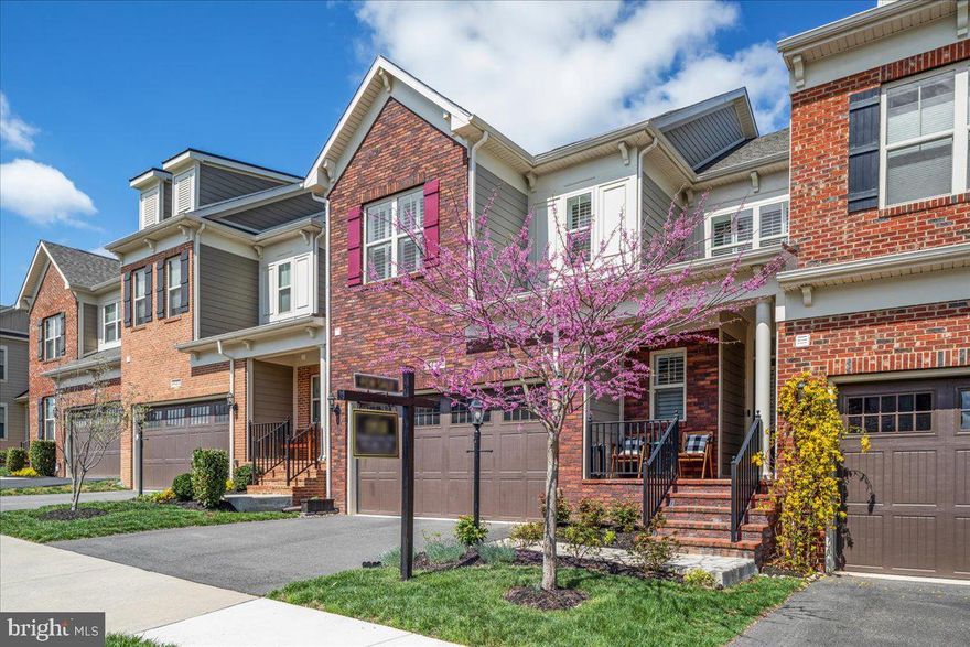 Stunning home in prestigious 55+ active adult community of Vistas at Lansdowne. Dramatic and impressive floorplan with grand vaulted two story family room and magnificent chef's dream kitchen. Inviting front porch and brick elevation offer beautiful charm and elegance. When you step through the threshold of this home you are greeted with beauty and sophistication; gorgeous trimwork, wide plank dark and impressive hardwood floors, and a welcoming open layout. 2 car garage with epoxy floors and storage. Plantation shutters throughout. Elegant dining room with shadowboxing wall to ceiling accent wall and plenty of space for your family gatherings. The gorgeous kitchen overlooking the soaring family room will surely impress. Phenomenal modern white kitchen with massive luxurious granite island with counter height breakfast bar, stainless steel appliances, double pantry, and high end Chiffon cabinetry. Grand family room with cozy gas fireplace, two story vaulted ceilings, and tall wall of windows and doors leading out to deck and fully fenced backyard. Main level primary suite with wall of windows, primary bathroom with double raised sinks, walk in closet and walk in shower. Lovely laundry room on main level with shelves and convenience. Upstairs you will find welcoming and spacious loft area that could be used as a second family room with beautiful overlook to family room below, 2 large secondary bedrooms with walk in closets, 3rd spacious and impressive room that is built out as a massive walk in closet dressing or storage room. Sprawling finished basement with large recreation room, full bathroom, 2 huge unfinished storage rooms, and double French doors.