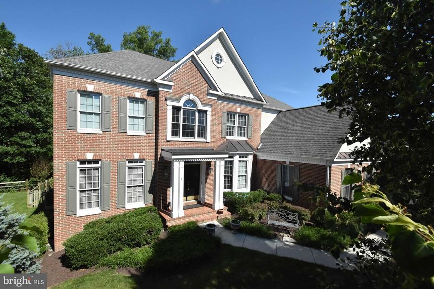 This immaculate South Riding home is situated on a tree-lined lot on a quiet street with mature landscape. Enjoy all new hardwoods on the main level including the foyer, living room, dining room, family room, & study. The family room includes a gorgeous floor to ceiling stone fireplace with raised hearth, palladian windows, & French doors leading out to the spacious deck. The gourmet kitchen is complete with center island & gas cooktop, granite countertops, cherry cabinetry, & a breakfast room with walls of windows. The luxury master suite includes a sitting room & spa master bath with double vanities, updated shower with frameless glass enclosure, & new lighting. All closets decked out by Closet By Design! Huge lower level rec room  with gas fireplace, full bedroom & bath, workshop room, + utility/storage room with additional washer dryer. Don't miss your opportunity to own a little slice of heaven in the heart of the convenient & family friendly South Riding community!