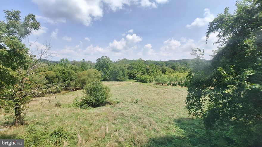 Nestled on a picturesque 3.86-acre parcel, this property is a blend of history and opportunity. There is a large home on the property ready for your renovation imagination or start fresh with your own plans to build your new home.  There is also an expansive barn, ideal for storage, workshops and the land itself is a canvas for gardens, outdoor living, or additional structures. Imagine your new home or revitalized piece of history overlooking breathtaking skyline views, with the soothing sound of Sams Creek  along the back of the property.