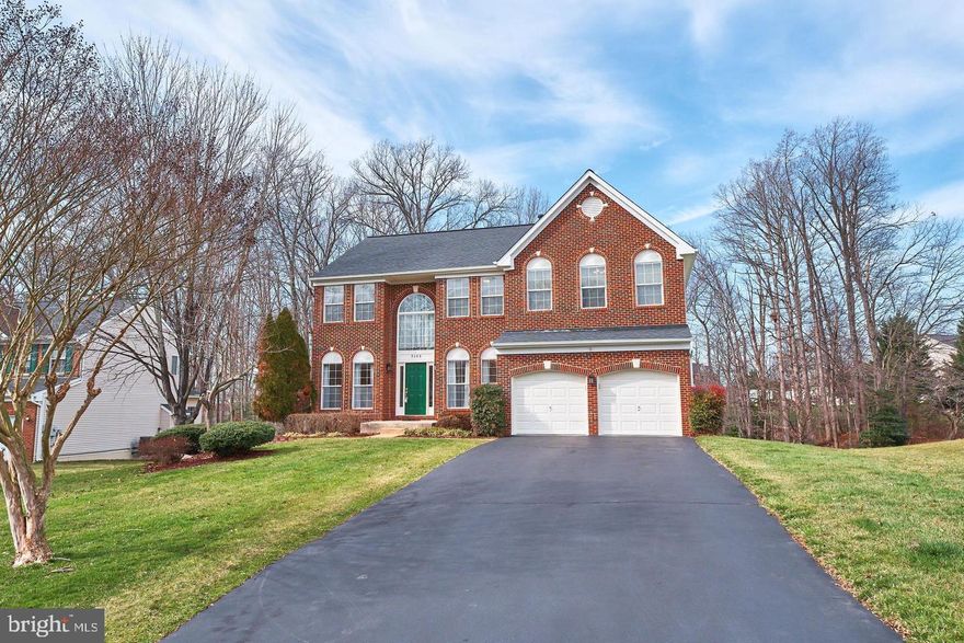 Beautiful brick colonial sits on a quiet cul-de-sac backing the trees. This house is the largest model in the sought-after Blooms Crossing community. The two-story foyer leads into a bright living room and a separate formal dining room that leads into the family room, and home office. The family room with a floor-to-ceiling stone gas fireplace is perfect for entertainment and gatherings. The spacious open kitchen with an island, an eat-in breakfast area, and a sliding glass door to the deck overlooks the natural scenery. The kitchen has 42” tall cabinets, granite countertops, glass tiled backsplash, stainless steel appliances (5-burner gas cooking range, double oven, dishwasher, double-door fridge), and a walk-in pantry. 9 ft ceiling and hardwood floors on the main level, New carpets on the upper floor, Ceiling recessed LED lights on all levels, new light fixtures, and water-saving elongated toilets have been installed. The upper level has an extra-large master suite with vaulted ceilings, and his and her walk-in closets. The master bath has a double sink vanity, a walk-in shower, and a separate soaking tub. There are four more spacious bedrooms with walk-in closets and a big shared bathroom. The deck has stairs to a paved patio and a gently sloping backyard surrounded by tall trees. It is perfect for outdoor living.  The bright walk-out basement with windows leads out to the patio. It has a full bathroom, two bonus rooms, and a recreation room.  A big walk-in storage closet, 2nd kitchen, and 2nd laundry room have been made recently in the basement. A maintenance-free walkway deck to the basement from the front of the house was recently built. Walk to a public elementary school and a private school, Blooms Park hiking trails, and a water park. Short distance to popular restaurants and shops on Liberia Avenue, route 28, and VRE station to DC. This amazing house is well-designed for living with in-laws or adult kids.