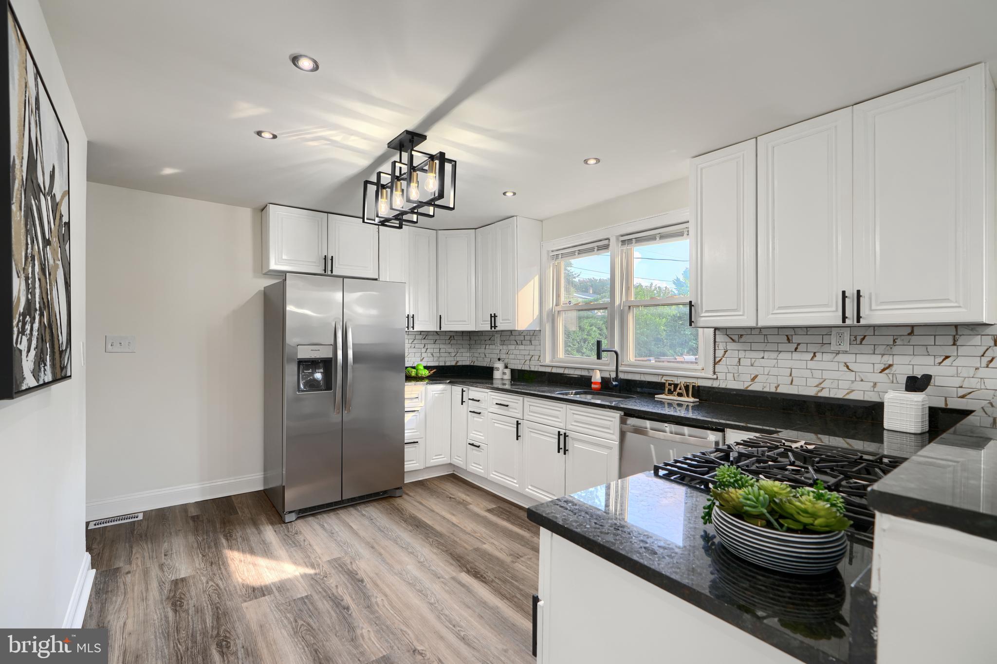 Welcome to 5409 Hillburn Ave, located on a quiet street in the highly sought-after Hamilton community, this beautifully updated 4-bedroom, 3-bathroom home offers the perfect blend of comfort, style, and functionality. As you step inside, you're greeted by a stunning fireplace, abundant natural light, and a stylish accent wall that adds a touch of sophistication. The spacious living room flows seamlessly into the formal dining area, featuring modern lighting and an open-concept layout—ideal for both everyday living and entertaining. The gourmet chef’s kitchen is a true showstopper, boasting ample counter and cabinet space, sleek stainless steel appliances, and a convenient breakfast bar for additional seating. Two well-appointed bedrooms and a full bathroom are conveniently located on the main level, perfect for guests or multigenerational living. Upstairs, you'll find a generous primary suite complete with a luxurious en suite bathroom. The fully finished basement extends the living space with a large rec room, an additional bedroom, a full bathroom, and a dedicated laundry room. Step outside to your private oasis, where a charming front porch and a rear deck overlook an expansive backyard—perfect for outdoor gatherings and relaxing evenings. Don’t miss the opportunity to make this exceptional property your new home!