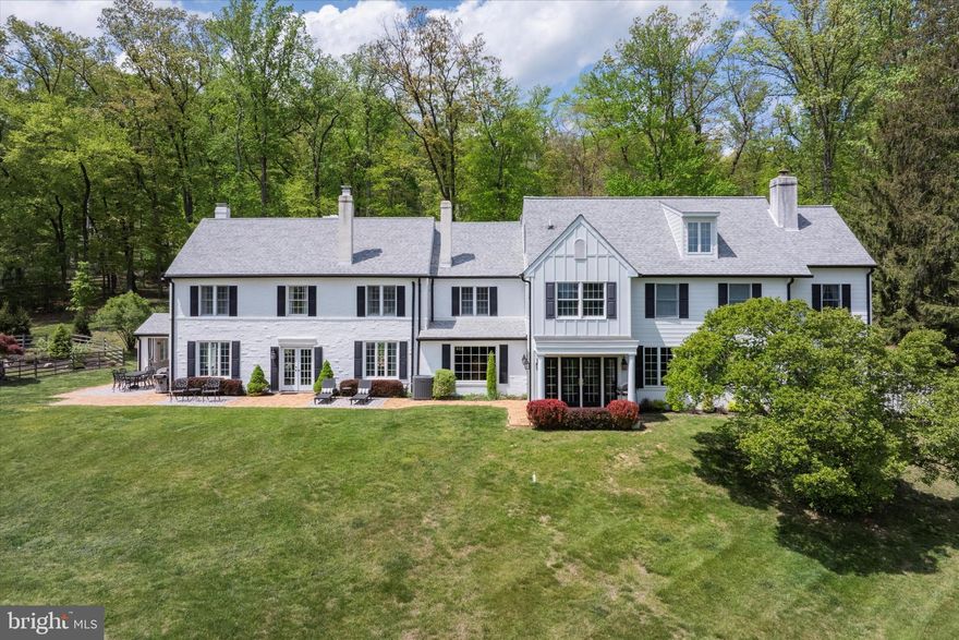 Discover the timeless elegance of 2031 Diamond Rock Hill Road, a stunningly restored and expanded 5-bedroom, 4.5-bathroom estate nestled on over 3 acres in the heart of Tredyffrin Township. This exceptional property offers breathtaking views, a serene landscape, and unparalleled privacy. Step inside the foyer, where expansive windows and French doors fill the home with natural light, creating a warm and inviting atmosphere. To your right, the oversized main living room offers an abundance of space, while straight ahead, the dining room leads seamlessly into the bar area—perfect for entertaining. Beyond, the chef’s kitchen is a masterpiece of craftsmanship, featuring custom cabinetry, granite countertops, a striking mosaic backsplash, and a cozy eat-in area. The open-concept design flows effortlessly into the family room, where a wood-burning fireplace and custom built-ins create a cozy yet refined gathering space. Nearby, you’ll find a powder room, a spacious walk-in pantry, and a mudroom with locker-style storage for added convenience. The main living area is both expansive and inviting, boasting a second fireplace and direct access to a picturesque patio with a covered cabana—an ideal setting for outdoor entertaining. Beyond the patio, a resort-style pool with a beach entry invites you to unwind, while a charming outdoor shower sits beside the home’s historic springhouse, adding a touch of character to this stunning property. The second level offers a private ensuite bedroom with its own bath, along with a luxurious primary suite that includes a fireplace, built-in bookcase, two walk-in closets with custom shelving, and a spa-like bath with a jacuzzi tub, dual vanities, and an oversized shower. Two additional spacious bedrooms, a hall bath with a tub/shower combo, and a convenient second-floor laundry room complete this level. On the top floor, you'll find a fifth bedroom, a full bath, and a versatile bonus space—ideal as a guest suite, home office, or recreation area. There is also additional storage space on this level. Blending historic charm with modern convenience, this extraordinary home is just steps from the trails of Valley Forge Mountain and minutes from Paoli Train Station, downtown Wayne, and Malvern, offering easy access to shopping, dining, and major roadways for commuting to Philadelphia and Wilmington. Located in the highly acclaimed Tredyffrin-Easttown School District, this is an opportunity to own a truly one-of-a-kind property.