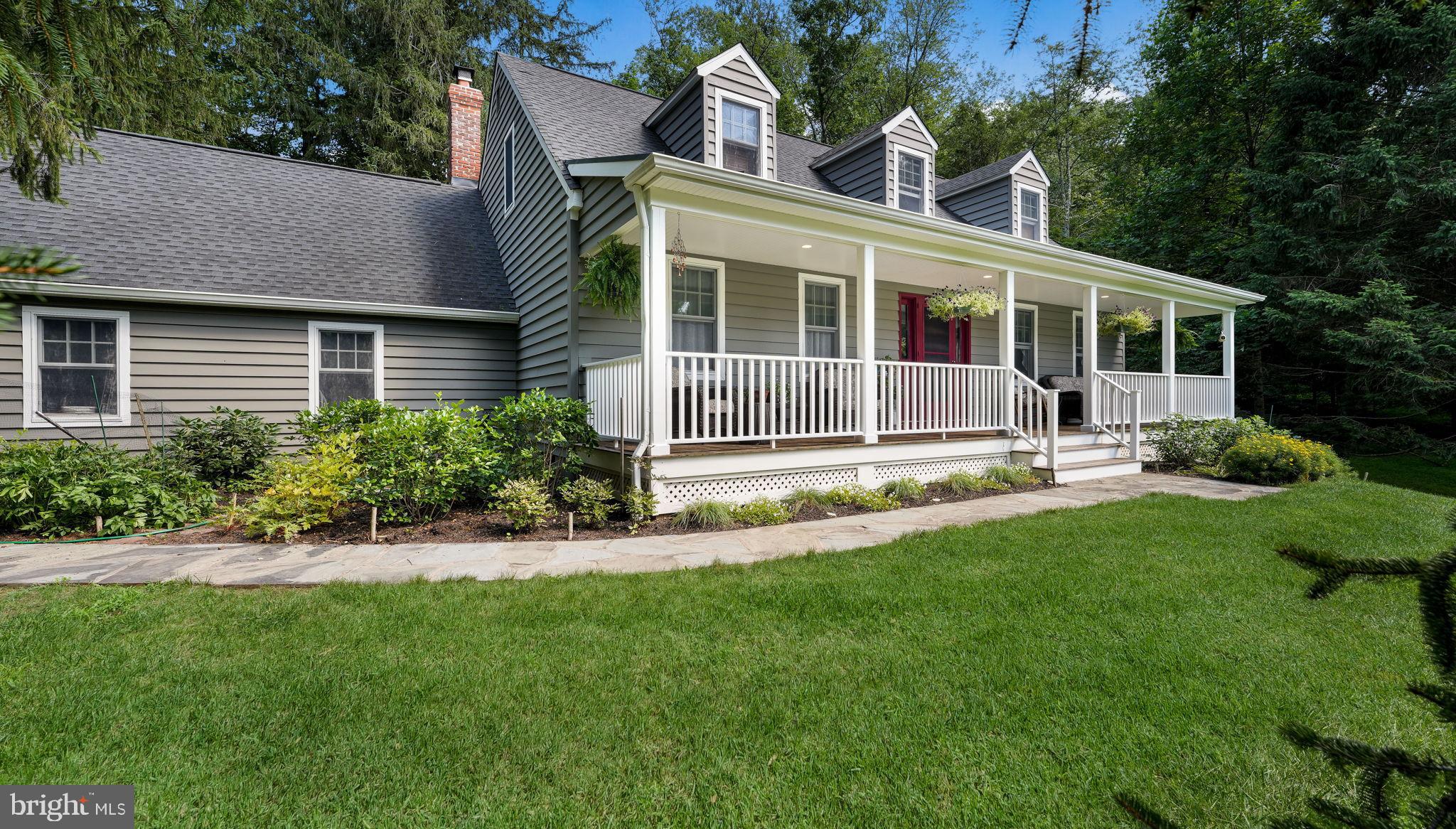 Nestled within a tranquil and private setting, this exceptional Cape Cod-style home masterfully combines classic architectural charm with thoughtful modern updates and superior craftsmanship. As you arrive down the private drive, you are welcomed by a newly paved driveway flanked by a beautiful stone wall and fencing on either side. An elegant flagstone walkway guides you to the inviting, covered front porch, the perfect spot for peaceful outdoor relaxation. Professionally curated mature landscaping surrounds the one plus acre property. Step inside to discover a warm and inviting main floor where gleaming new hardwood floors flow seamlessly throughout the living and family rooms. The family room boasts custom built-in cabinetry framing a striking fireplace with a freshly updated surround, while added French doors flood the space with natural light and provide easy access to the outdoors. In the living room, a new double window invites abundant sunlight, creating an airy and open atmosphere. The formal dining room is adorned with a charming bay window featuring built-in bench seating and cleverly concealed storage, ideal for both everyday use and elegant entertaining. A versatile first floor office, also suited as a fourth bedroom, features hardwood flooring and provides a flexible living space option. Throughout the main level, solid wood doors, refined moldings, and updated hardware add an element of timeless sophistication and quality. The heart of the home, the kitchen, has been fully transformed into a chef’s dream with rich cherry cabinetry, gleaming granite countertops, a stylish tile backsplash, ceramic tile flooring, and premium, high-end appliances. Peninsula island seating adds both beauty and functionality. Just steps away, a half bath and remodeled laundry room features custom built-in cabinetry, generous workspace for added convenience, and recessed lighting. Upstairs, the primary suite is a private sanctuary featuring hardwood floors, woven wood blinds, and thoughtfully designed under-eave closets with custom organizational inserts. The luxurious ensuite bathroom has been beautifully expanded to maximize space and outfitted with upscale finishes and a space-saving pocket door for elegance and practicality. The second and third bedrooms are equally inviting, showcasing hardwood flooring, custom closet solutions, and new blinds for a polished, comfortable feel. The second-floor hallway is enhanced by matching hardwood floors and custom linen cabinetry with drawers, adding both style and storage. A second full bathroom has been tastefully remodeled with modern fixtures and refined tile work, delivering both beauty and comfort. Additional enhancements include a recently replaced roof, Andersen windows that bathe the home in natural light while ensuring energy efficiency, and upgraded mechanical systems including a neutralizer replacement and a new septic system for peace of mind. The basement has been professionally waterproofed with a battery backup sump pump to protect the home from moisture concerns. Outside, the home’s appeal continues with a flagstone patio, creating a natural flow between indoor and outdoor living. Extensive landscaping around the home and driveway, expertly maintained over the years, enhances privacy and visual appeal. Completing the exterior is a spacious two car garage and a fresh coat of paint on the home's exterior, restoring its crisp and clean finish. This move-in-ready home presents a rare opportunity to own a meticulously maintained home that effortlessly balances charm with modern conveniences, creating an elegant, comfortable, and highly functional living experience from the inviting exterior to the beautifully appointed interior and serene outdoor spaces. Top rated Central Bucks schools. Quick access to nearby parks. This home delivers a lifestyle of comfort, convenience, and outdoor enjoyment. Wow!