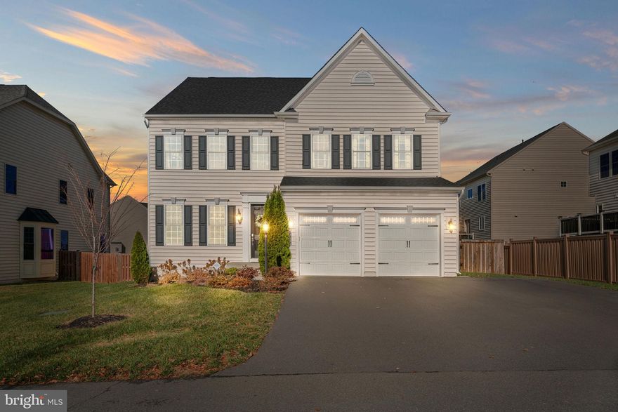 Welcome home to the sought-after neighborhood of Wentworth Green! This stunning colonial features 4 bedrooms, 4 1/2 baths, and over 4,500 sq ft of living space with upgrades throughout. Upon entering the home, you are welcomed by the sun drenched, 2-story foyer and gleaming hand-scaped, wide plank hardwood floors. Modern 8’ doors and 10’ ceilings highlighted by recessed lighting throughout. The gourmet kitchen has stainless steel appliances, granite countertops, breakfast bar, butler pantry, and an eat-in area. The kitchen overlooks the spacious family room with cozy gas fireplace, built-in surround sound stereo system, and convenient access to the newly installed trex deck. Perfect for entertaining! The elegant formal dining room features a coffered ceiling and wainscotting. The main level is complete with a separate formal living room and a home office, perfect for your telecommuting needs! The upper level features the primary suite with tray ceilings and 2 walk-in closets. The luxurious ensuite bath has separate quartz vanities, spa like soaking tub, and dual head shower with built-in bench. Plenty of room for family and guests in the ensuite guest room with private bath and 2 additional bedrooms connected with a Jack and Jill bath. The lower level is an entertainer’s dream featuring a custom-built wet bar with wine fridge, newly installed modern electric fireplace and plenty of space for recreational activities. The lower level is complete with a bonus room and a full bath.  With the fully fenced backyard, this home gives you hours of outdoor fun! Take advantage of all the amenities Wentworth Green has to offer, including the pool, dog park and paved walking trail leading to the Promenade at Virginia Gateway! The neighborhood is ideally positioned for living convenience only minutes to shopping and restaurants, major commuter routes, Lifetime Fitness and Gainesville Middle and High School. Run, don’t walk! This one wont last long. Schedule your tour today!