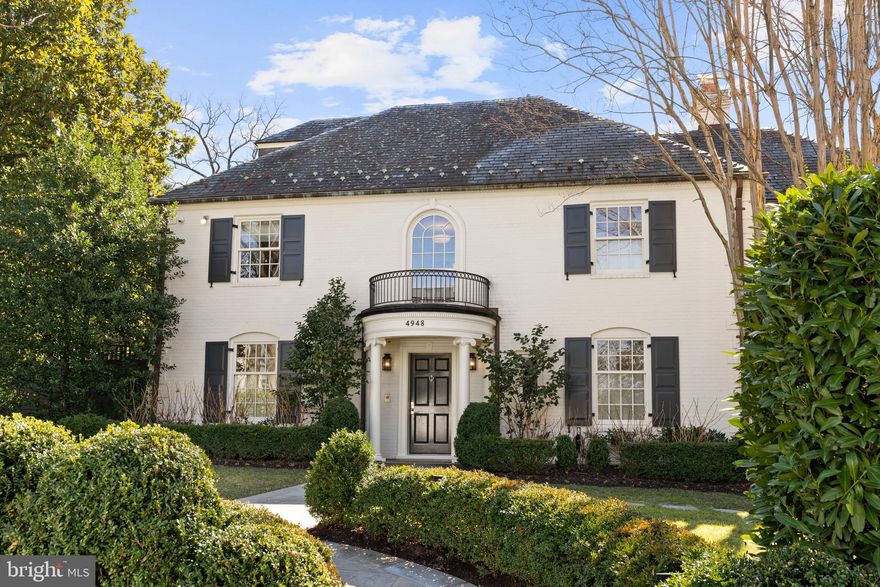 This impressive Colonial Revival is desirably located on a generous .36-acre lot on one of the most sought-after streets in Washington, DC. The house is set back from the street behind a row of hedges, providing privacy while still providing impressive curb appeal. Originally built in 1939, the house has been expanded to nearly 7,000 square feet of interior living space. The residence has undergone extensive renovations with the masterful collaboration of Horizon Builders, BarnesVanze Architects, and Andrew Law Interior Design. No detail was overlooked in this meticulous renovation, which includes the highest quality fixtures and finishes throughout. The house features elegant entertaining rooms and comfortable family living spaces, all of which are filled with an abundance of natural sunlight. The gracious foyer has sightline views to the rear of the house and provides seamless transition to the main living spaces. The formal living room is flooded with sunlight and includes a large bay window and offers convenient access to the neighboring wood-paneled office with built-ins. The sophisticated dining room is beautifully scaled and has a lovely central fireplace. Adjacent is the well-appointed gourmet kitchen with marble countertops and backsplash, a large center island with a breakfast bar, abundant cabinetry, and a walk-in pantry with an ice maker. The kitchen opens to the breakfast room and then to the newly enclosed sunroom, which has walls of windows on all sides and overhead skylights. The kitchen provides exterior access through French doors to the private side terrace and garden. There is also a large paneled family room/library on this floor with built-in shelving and cabinetry, as well as the added convenience of an attractive marble powder room. A lovely staircase leads to the second level, which offers four bedrooms and three full bathrooms. The luxurious primary suite is expansive and overlooks the rear yard and gardens. It offers two walk-in closets, including an impressive custom dressing room, as well as a discrete coffee bar with a sink and refrigerator. The spa-inspired en-suite bathroom is well-appointed with marble dual vanities, a frameless glass shower, and large separate soaking tub and separate water closet. The bathroom also provides access to the private balcony off the primary suite. All of the additional bedrooms on this floor are spacious and all bathrooms have been beautifully updated. The third floor has an additional bedroom suite with a luxurious bathroom and ample closets. The lower level of the residence has a large recreation room with a wet bar and secondary refrigerator and freezer. It adjoins a generous mudroom with cubbies, a sink, ample storage, and access to the oversized three-car tandem garage. This level also offers a full bathroom, temperature-controlled wine room, and a spacious laundry room with utility sink and storage. There is exterior access from the lower level to the manicured rear grounds. The exterior of the property has been expanded to include a large terrace with an outdoor kitchen and multiple entertaining areas. The terrace overlooks the expansive pool-sized flat yard with beautiful professional landscaping with lighting and a play area. The newly redone driveway is private and has a secure access gate.