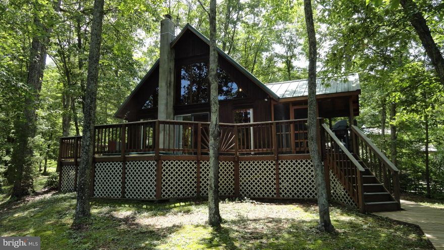 LAKE FRONT Log home with its own PRIVATE BEACH & Floating Dock.BEAUTIFAUL PRIVATE wooded lot.Trex Deck.Hot Tub. Screen Porch. Wooden plank Walkways. W/O Basement makes perfect Rec Room. 3rd Bedroom is a loft area featuring a Full Bath & more VIEWS of the Lake!! So close but a world away-only minutes from Leesburg, Frederick, Martinsburg.  Don't miss out on the AWESOME property!!! Comcast available
