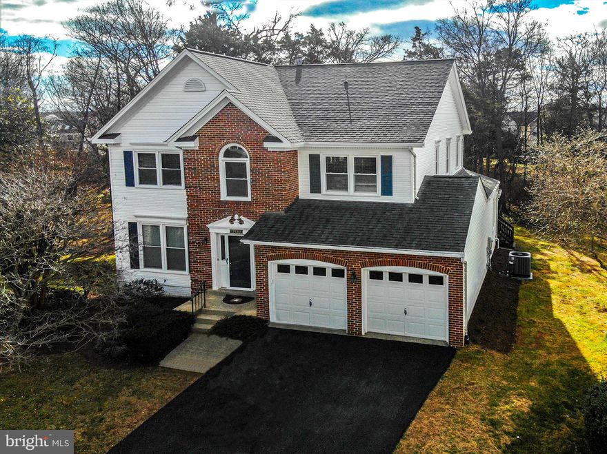 Stunning brick-front Colonial perfectly sited on a picturesque 1/3-acre cul-de-sac lot backing to trees and community open space. From the moment you enter, you’re welcomed by a dramatic two-story foyer highlighted by a breathtaking curved staircase and abundant natural light that sets the tone for this elegant yet comfortable home. The chef’s kitchen features stainless steel appliances, granite countertops, and opens seamlessly to a spacious family room anchored by a classic brick fireplace. Large windows frame beautiful views of the custom deck and level backyard—an ideal setting for outdoor entertaining, relaxing evenings, and everyday living. Designed with both function and style in mind, the open floor plan includes a great living room and dining room made for memorable gatherings, and a convenient mudroom off the garage with a full-size washer and dryer plus additional storage. Upstairs you’ll find four generously sized bedrooms, including an impressive owner’s suite featuring a luxurious garden bath, walk-in closet, and a spacious sitting room that creates a true private retreat. Three additional bedrooms offer comfortable space for family and guests. This home is truly move-in ready with fresh paint throughout, brand-new plush carpeting, a brand new HVAC system; the roof, windows and SS appliances have been replaced as well. 
All of this in a sought-after community within the highly ranked CHS school pyramid, with easy access to scenic walking and biking trails, a beautiful community pool and clubhouse, nearby shopping and restaurants, and convenient access to major commuter routes.  You won't want to miss this exceptional home!