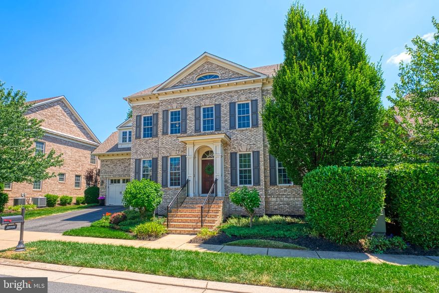 PRICE IMPROVEMENT - don't miss this one! Do you want to live in one of the most charming areas in Brambleton? This is it!! Gorgeous Gulick ALL BRICK home within walking distance of the Brambleton Town Center shops & restaurants. Walking in, you will quickly realize the quality that sets Gulick Homes apart from many other builders. This home is occupied to the original owners who added many upgrades when purchasing it. The spacious open main level features gorgeous solid hardwood floors, a stunning gourmet kitchen with a large granite island, high-end stainless steel appliances, and a butler's pantry. The beautiful family room with a gas fireplace leads to a party-friendly deck, perfect for family gatherings and entertaining. The home also has a first-floor office, a beautiful living room, and a spacious dining room. The second level includes the primary suite with TWO walk-in closets, a soaking tub, and dual vanities. The primary suite also has a sitting room with a fireplace and access to an outdoor balcony, a perfect place to enjoy morning coffee. Four additional spacious bedrooms complete the upstairs, including two en-suites and a fourth full bathroom. The lower level of this home is fully finished with a recreation room with a bar, a media room, and storage space. It also has a sixth bedroom and a fifth full bathroom, making it the perfect place for an exercise room, nanny, or family staying for extended periods of time. The outdoor lighting and in-ground irrigation system help you keep the outdoor space looking great. This home also has a 3-car garage.  Brambleton is an amenity rich community with 4 outdoor pools, tennis/pickleball courts, walking trails, basketball hoops, a sand volleybal pit, and more. The Brambleton HOA includes Verizon FIOS Internet and Cable TV, trash and recycling services, and maintenance of common grounds. This house is simply fantastic! Don't miss the opportunity to make it yours.