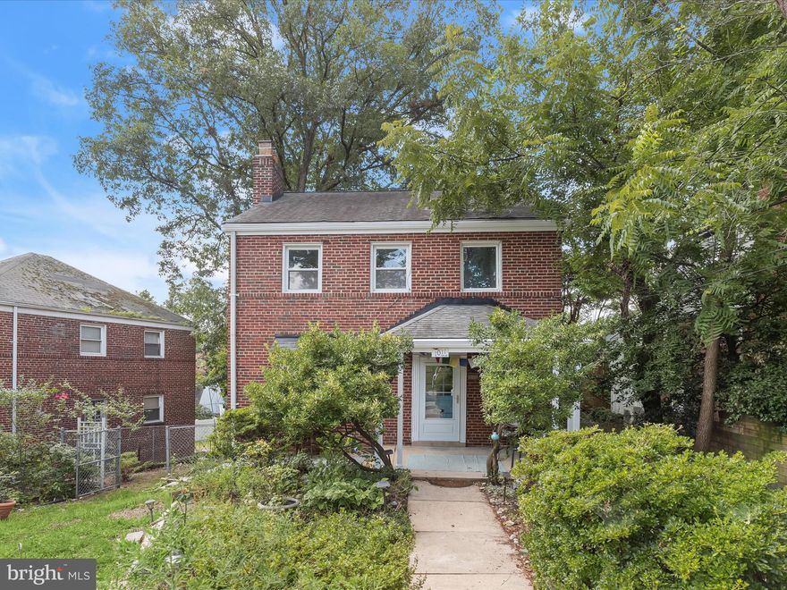 Brimming with charm and modern updates, this classic brick colonial blends timeless appeal with today’s comforts in an ideal Takoma Park location. A lush front herb and rose garden leads to a covered front porch, setting a warm and welcoming tone before you even step inside. Hardwood floors flow throughout the main level, beginning in the spacious living room where a bay window frames views of the front yard. The fireplace adds character and is currently nonfunctional, but can easily be made functional once again. In the adjacent dining room, chair rail molding and a sliding glass door connect seamlessly to the oversized back deck perfect for entertaining or everyday enjoyment. The renovated kitchen balances style and efficiency, featuring white cabinetry, quartz countertops, and stainless steel appliances. Additional cabinetry on the opposite wall, topped with a butcher block counter, provides bonus prep space and storage. A recently updated powder room on the main level adds to the home’s everyday functionality. Upstairs, three bright bedrooms share a renovated full bath that blends classic and contemporary elements. The black and white color palette is timeless, while a modern vessel sink and a floor-to-ceiling tiled shower elevate the space with a fresh, current feel. The lower level offers flexible space to meet your needs. One half is partially finished and ideal for a recreation room, home gym, or creative space. The other half houses laundry, utilities, and generous storage. Step outside to find a private and expansive backyard bordered by mature trees, offering plenty of space to relax, play, or garden. The oversized deck has been updated with new beams, and additional recent improvements include chimney coping and masonry updates, new exterior steps on the side of the house, and a rewired circuit breaker panel prepped for future expansion. Ample street parking adds everyday convenience for you and your guests. Just moments from Sligo Creek Park and its miles of trails and green space, this home is ideally located near downtown Takoma Park, the Metro, three major bus lines, and the soon-to-open Purple Line. With Washington, D.C. only minutes away, you’ll enjoy the perfect mix of character, convenience, and connection. Please note: photos of some rooms have utilized virtual staging.
