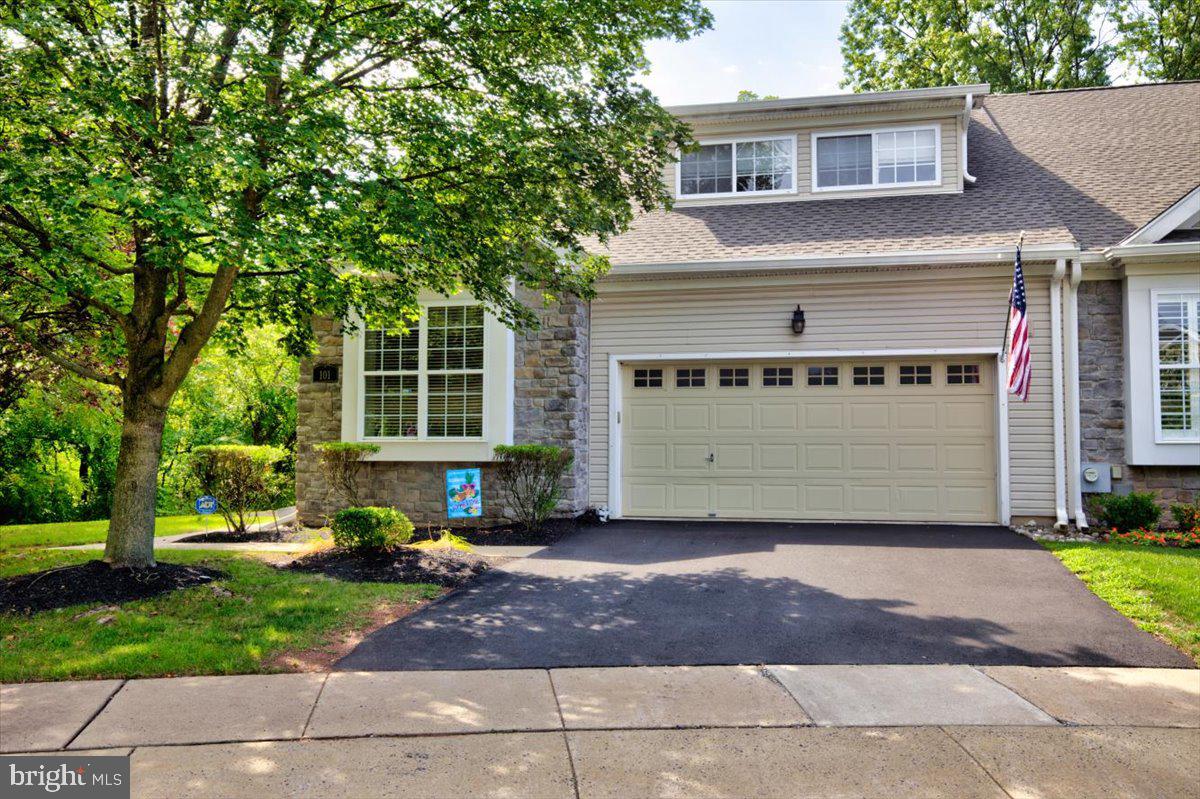 Don’t miss this rare opportunity to own a stunning end-unit carriage home in the highly sought-after 55+ community, The Courtyards in Collegeville. Perfectly positioned at the end of the development, this home is surrounded on two sides by mature trees, offering exceptional privacy and the serene feeling of living in a wooded retreat—while still being part of a warm, welcoming neighborhood. Ideally located near Evansburg State Park, the Perkiomen Creek walking trail, and the many shops, restaurants, and amenities along Ridge Pike and in Lower Providence Township.
Step inside to a spacious, open floor plan designed for comfort and style. The formal dining room is beautifully detailed with crown molding, wainscoting, and a large sun-filled window. The expansive living room seamlessly connects to the kitchen and sunroom, creating an airy, inviting space perfect for relaxing or entertaining. The sunroom opens to a private deck, where you can enjoy peaceful wooded views year-round.
The first-floor primary suite features a large walk-in closet and a full bath with a double-sink vanity, elegant tile flooring, and a spacious walk-in shower. A second bedroom—ideal as a guest room, den, or home office—sits just off the entryway alongside another full bath. A laundry room with utility sink and direct access to the 2-car garage adds everyday convenience.
Upstairs, a versatile third bedroom/bonus room offers a massive walk-in closet, perfect for guests or extra storage. The full, unfinished basement with egress window provides endless potential for additional living space while maintaining plenty of storage.
This home has been recently updated with a new roof, and the monthly association fee covers landscaping, exterior maintenance, and neighborhood upkeep for low-maintenance living. The Courtyards is a quiet, safe community where homes rarely become available—making this a truly special offering.